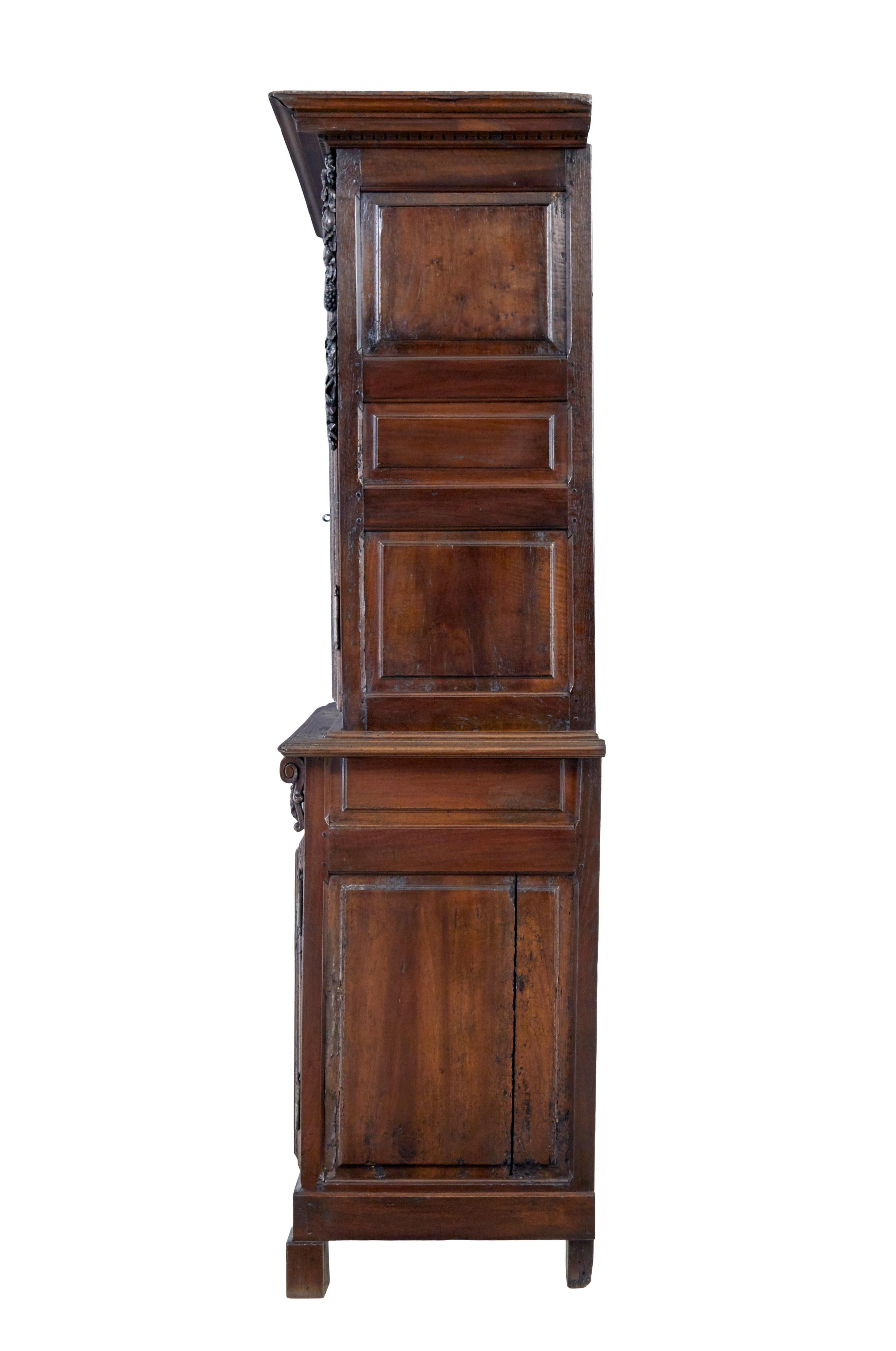 Rustic 18th Century French carved walnut cupboard For Sale