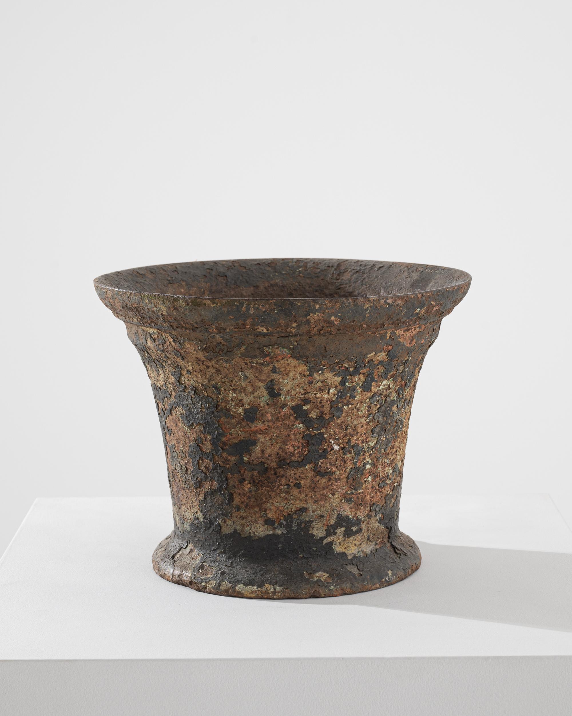 This cast iron mortar and pestle was made in France in the 1700s. In the eighteenth century, this important device would equip most chemists and apothecaries, mortar and pestles were used to grind spices or mix ointments. The chalice-shaped mortar
