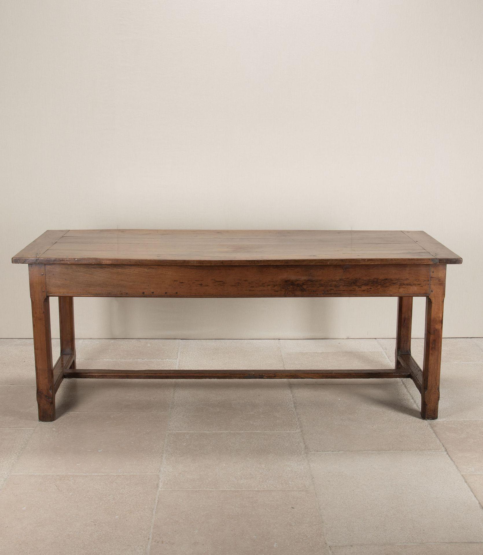 A good late 18th Century French cherry wood dining table.
With two drawers, canted corners on the legs and a stretcher for added stability underneath.
Dating from around 1780.With some restoration.