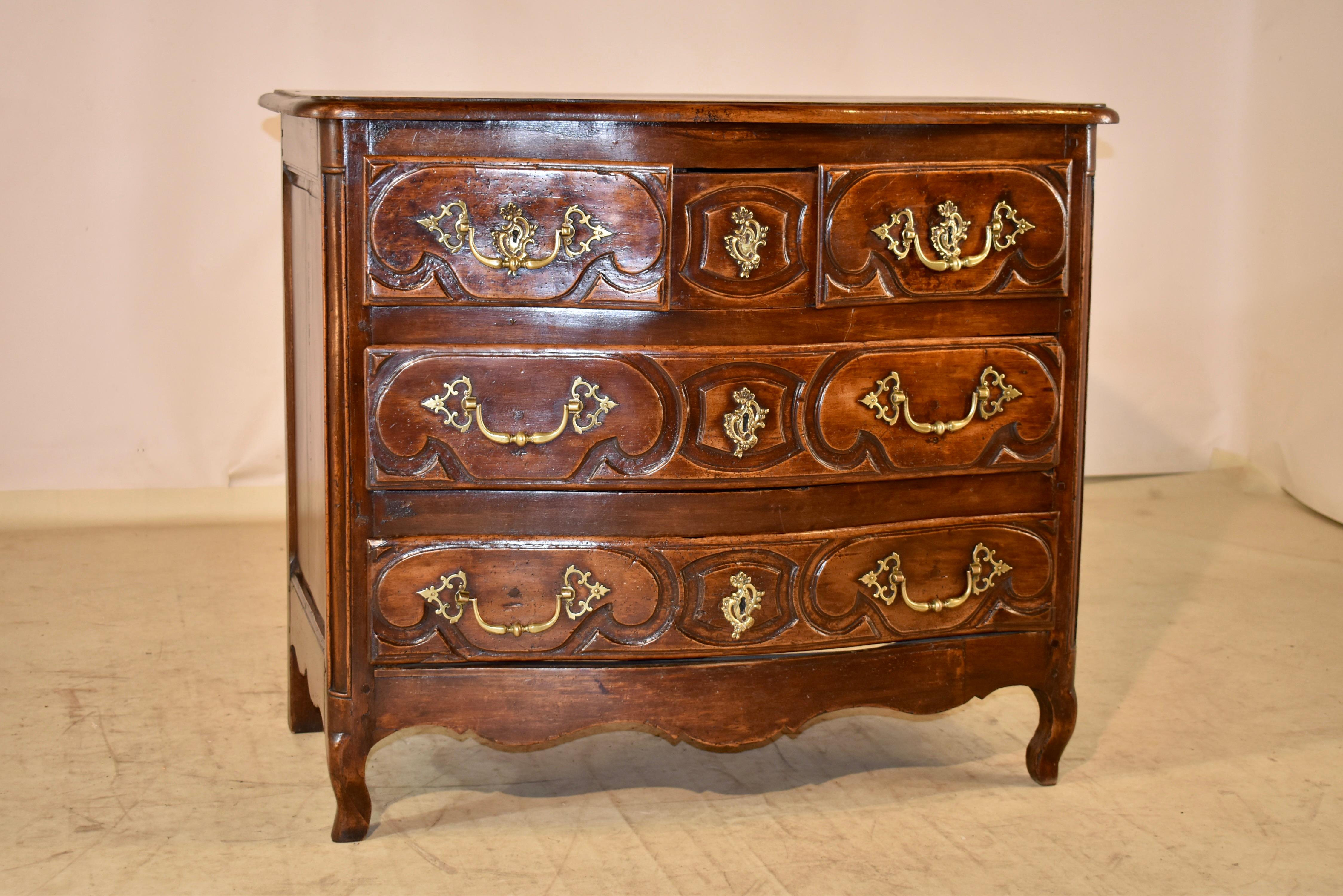 18th century French chest of drawers made from oak and walnut.  The top is made from oak and has a serpentine and beveled edge around the top, following down to beautifully hand paneled sides with scalloping on the skirt.  The chest has three