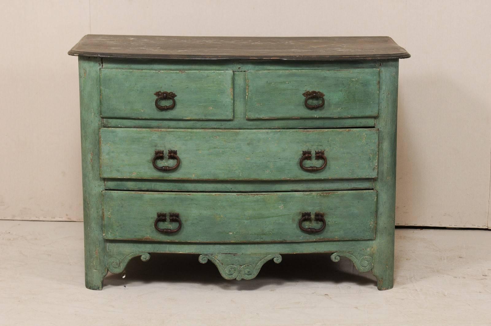 A French 18th century four-drawer painted wood chest. This antique French chest is good sized and has a slightly bowed front and slightly overhung top, set above two half drawers over two full drawers, each with nice old chunky iron hardware. Each
