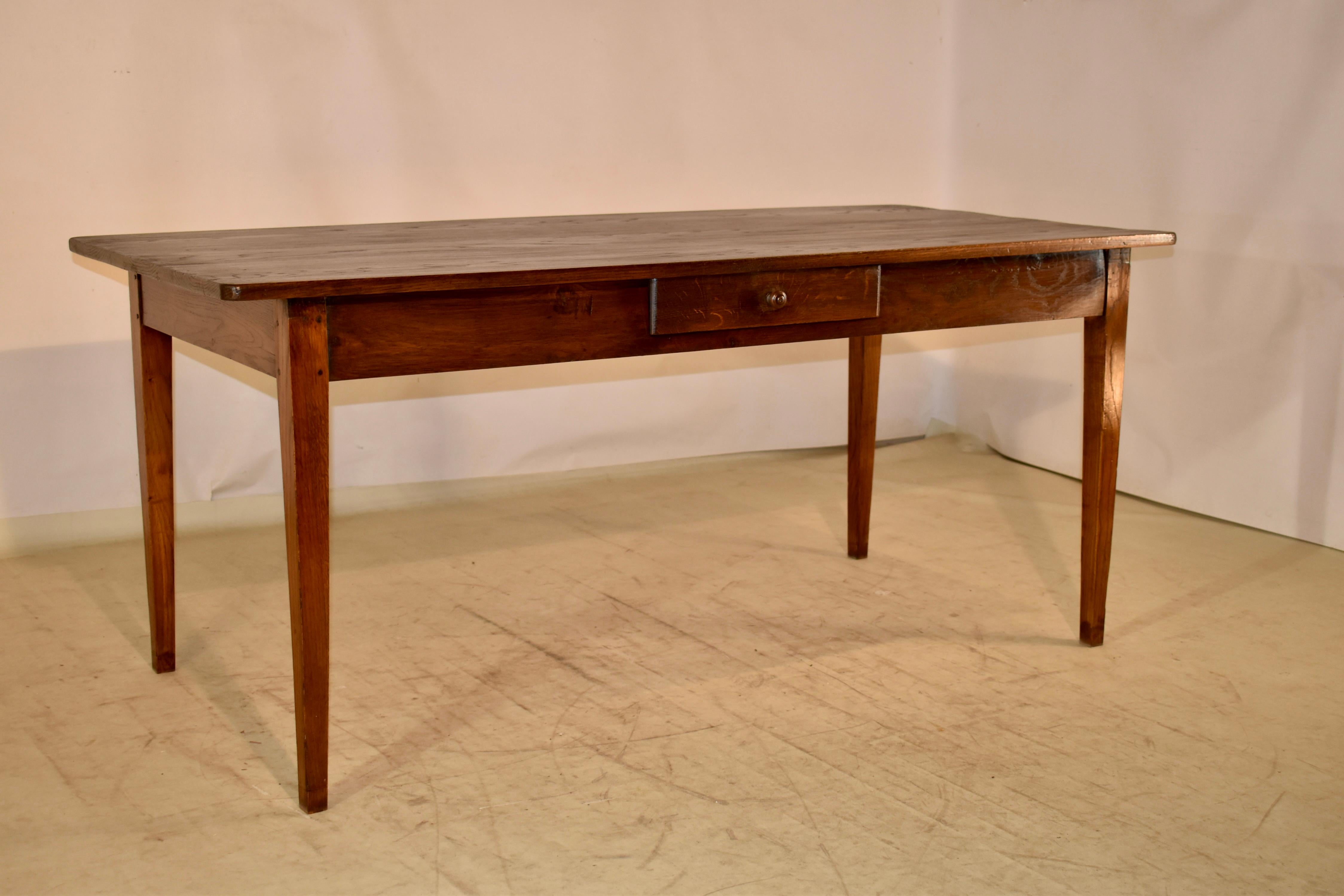 18th century farm table from France and made from Chestnut.  The top is wonderfully grained, and follows down to a simple apron.  The apron contains a single drawer and the table is supported on hand tapered legs.  The apron height is 25 inches.