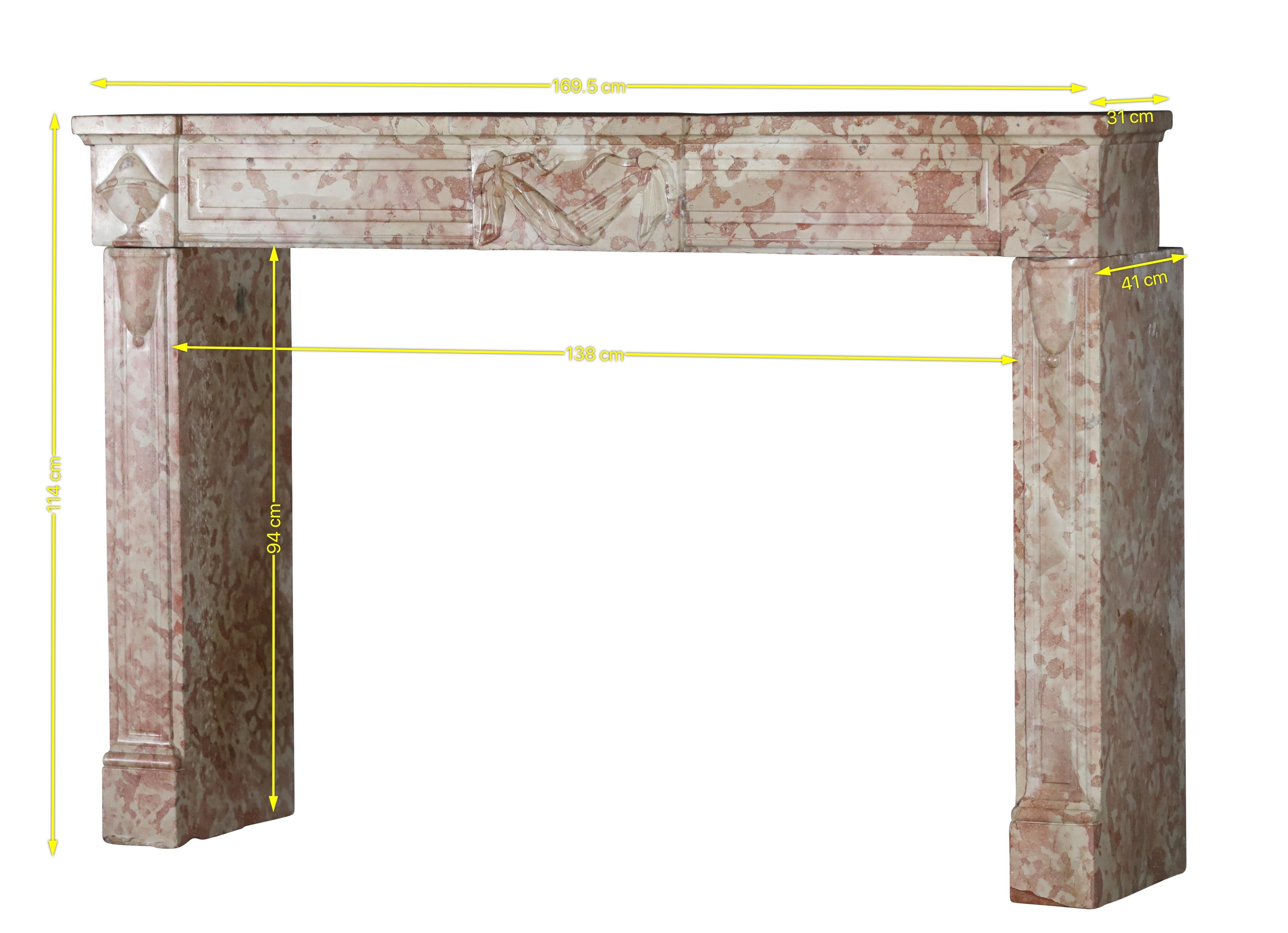 This 18th-century French marble stone fireplace surround is truly a statement piece. With its ivory and pink rose coloration, it exudes an elegant charm that would enhance any grand interior. Designed in the Louis XVI style, it features intricate
