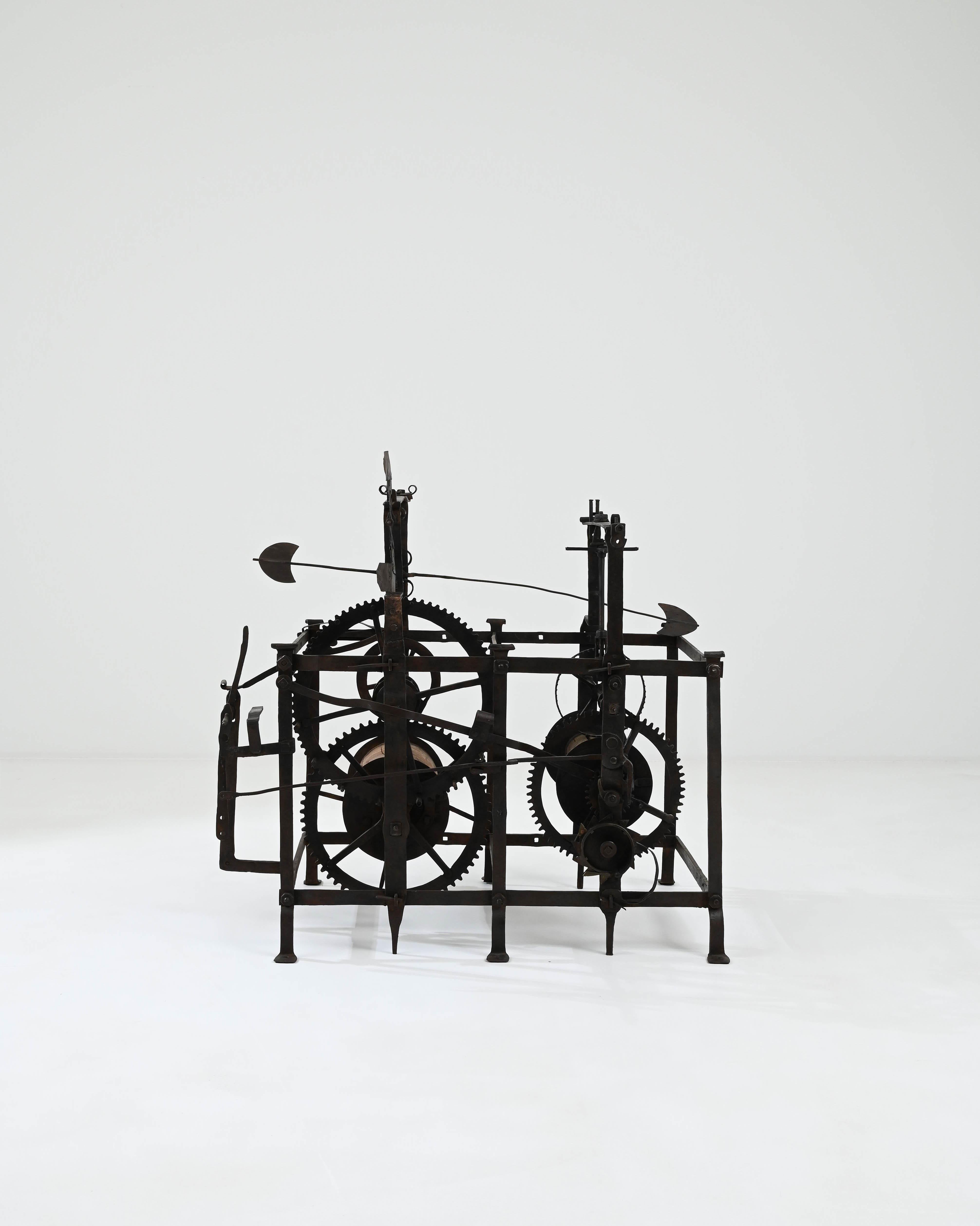 The sculptural silhouette of this antique iron clock mechanism draws the eye and ignites the imagination. Made in France in the 1700s, this piece offers a slice of history: one of the inventions that ushered in the Industrial Age, the cutting edge