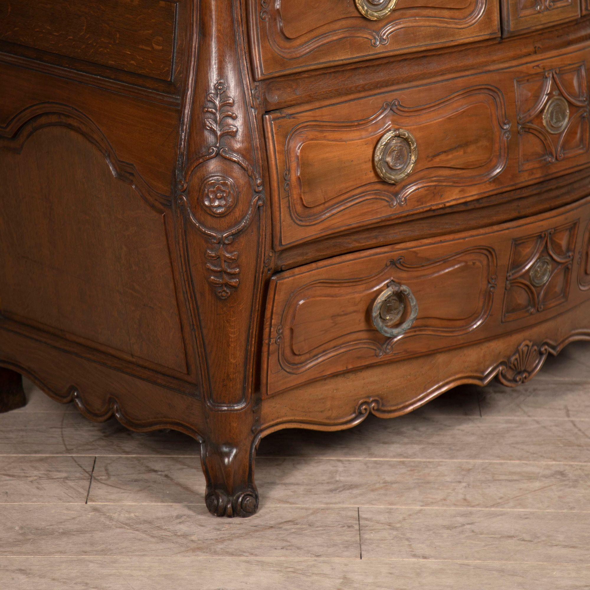 18th century French commode.
A fine quality Louis XV period walnut commode of most attractive colour.
Of bombe form consisting of three short drawers over two long drawers with a shell-centred carved scroll apron supported on short scroll feet.