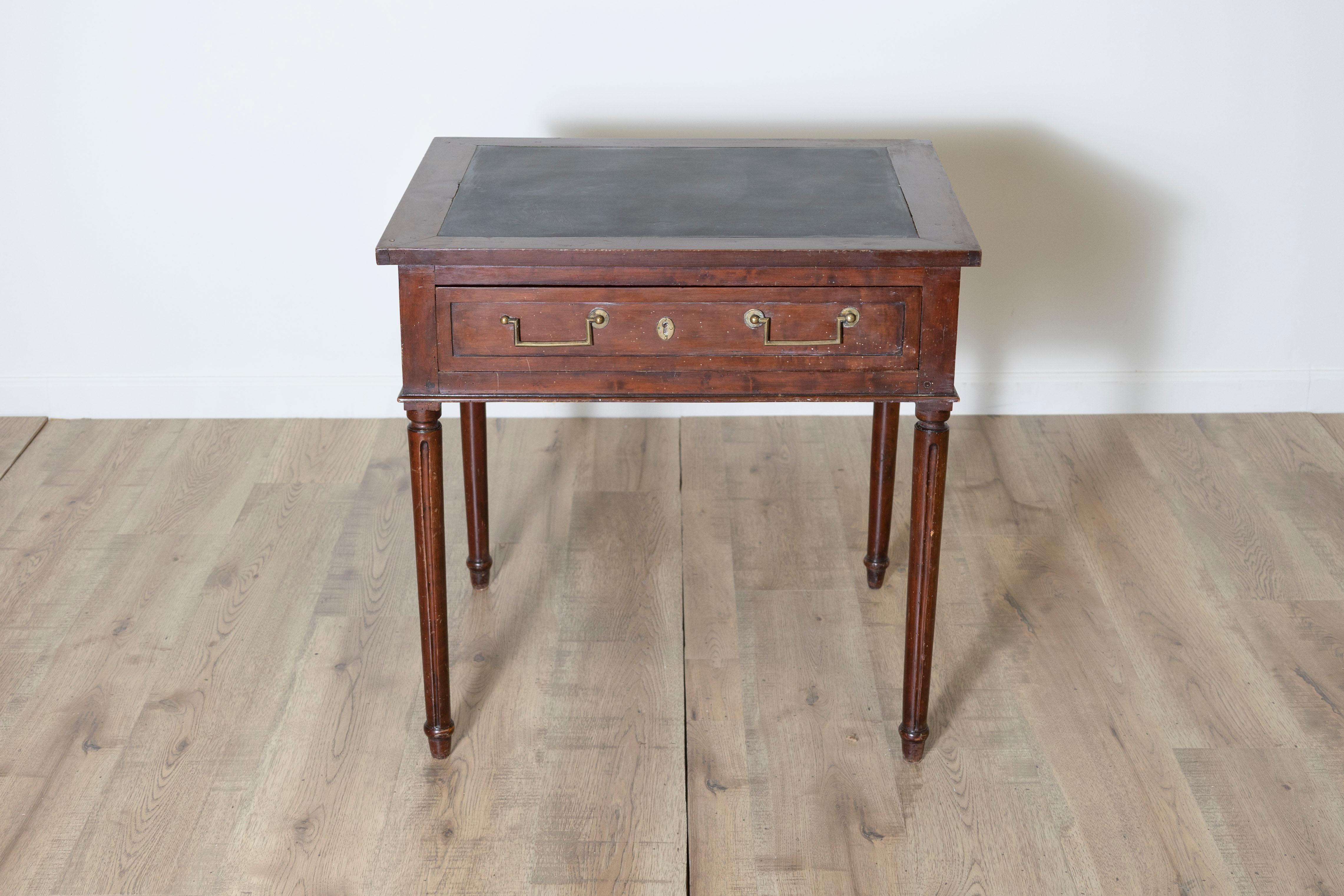 This elegant 18th-century French console table is a fine example of Louis XVI style, reflecting neoclassical elegance and timeless craftsmanship. Made from walnut, it features a rectangular top with an inset black leather surface, adding a refined