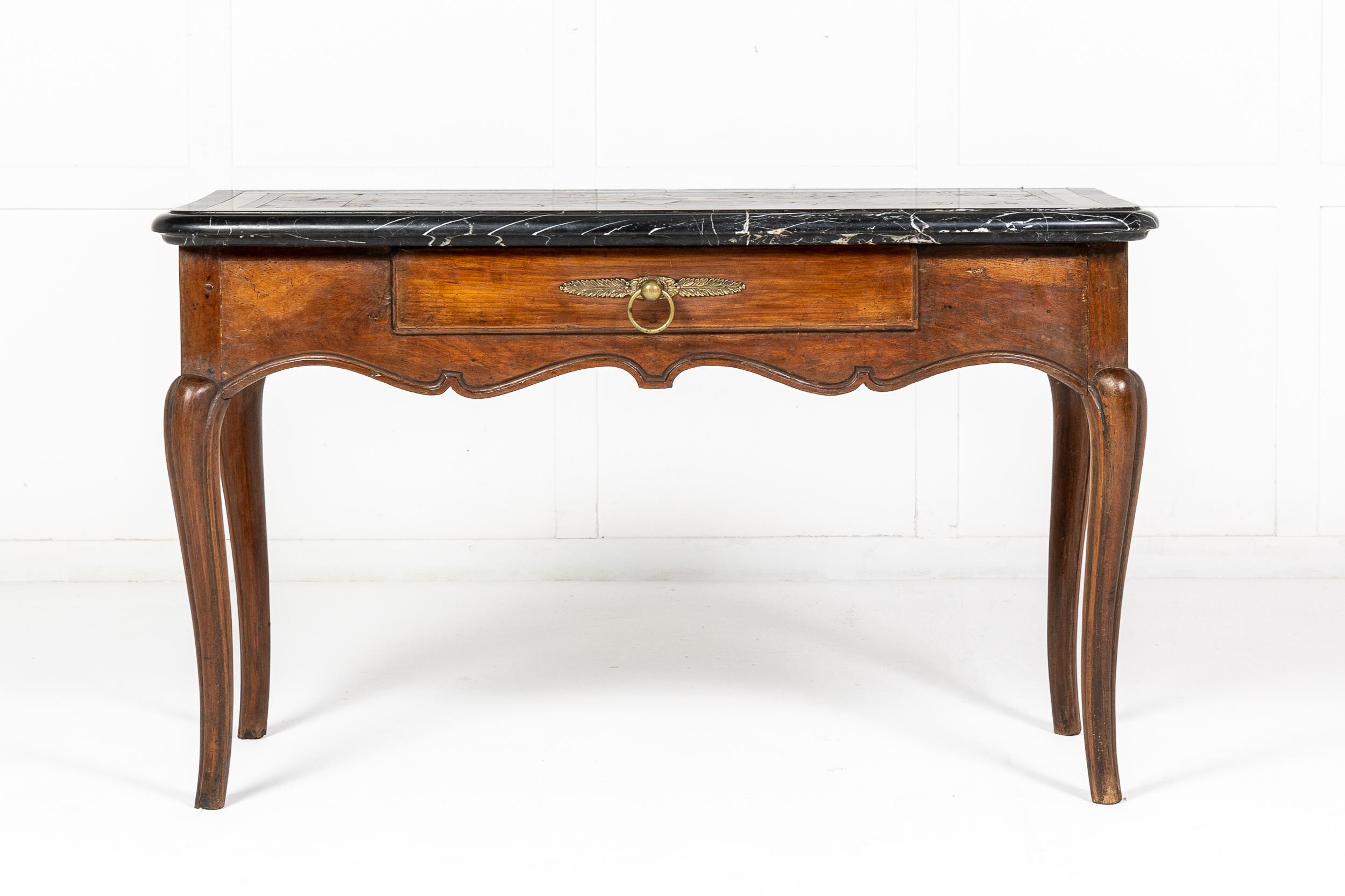 A classic French 18th century console table with outstanding thick top of various marbles having a central star motif.
The deep carved and moulded frieze, has a single central drawer, with a large ring pull handle, adjoining long cabriole legs.