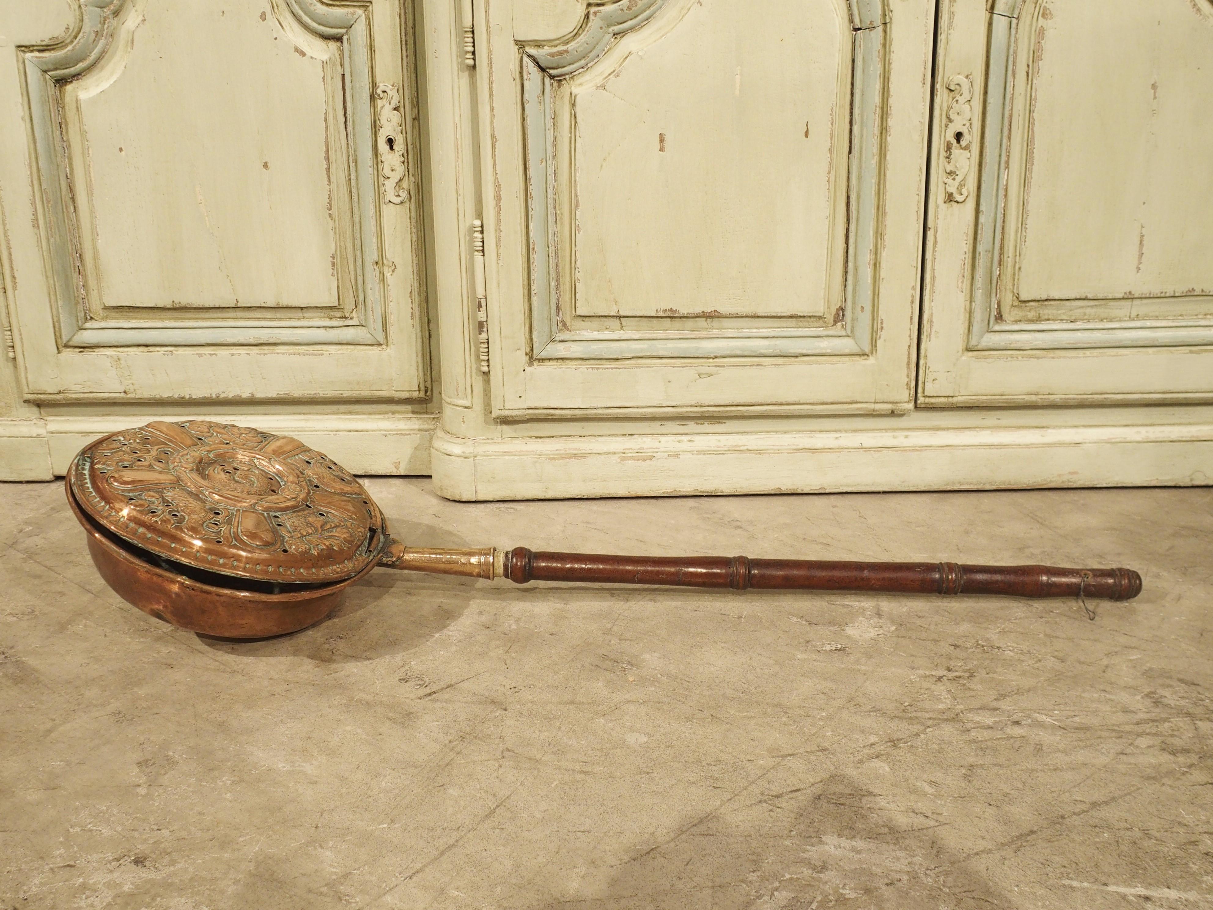 This French copper bassinoire, or bed warmer, has a wooden handle and was produced in the 1700’s. Hot coals would be placed into a bassinoire’s vented receptacle, and the user would pass the device under the covers, warming the bed. Copper was the