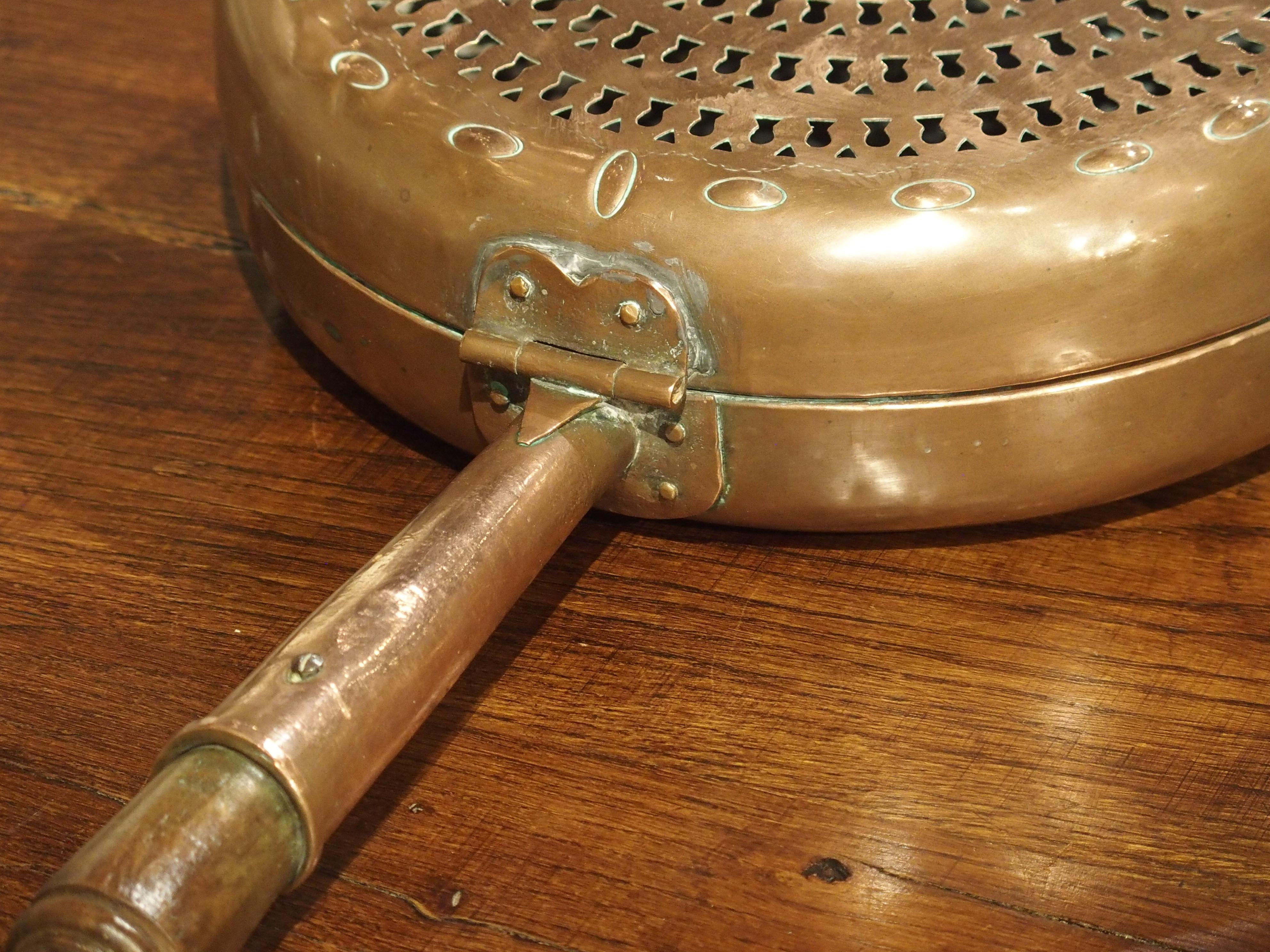 This interesting copper bassinoire with turned wood handle is from the 1700’s. A bassinoire is an old French instrument used to heat a bed. A hot material, such as coals or embers, would be placed into a metal receptacle. Copper was the preferred