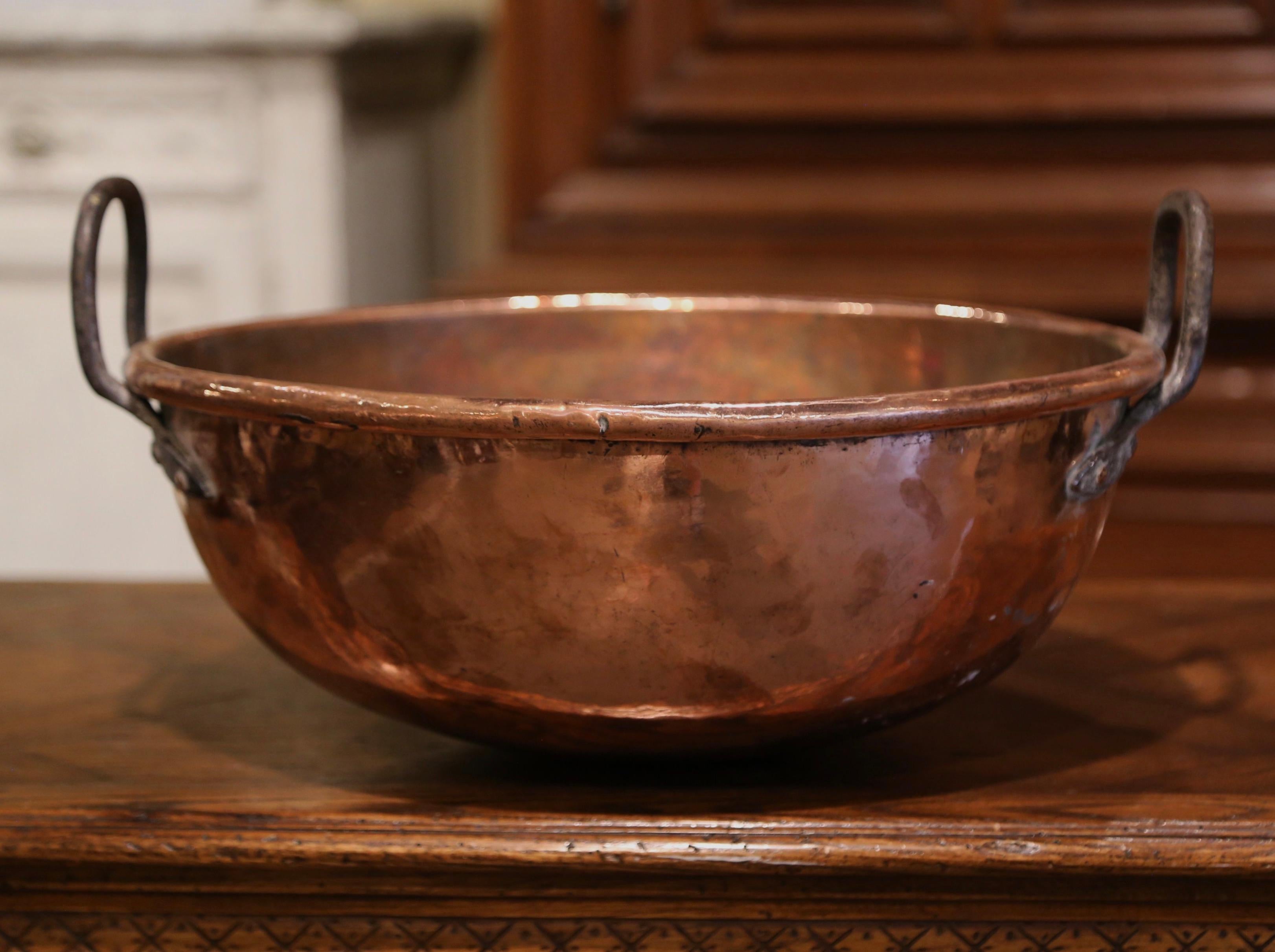 Bring an authentic French countryside touch to your kitchen with this large antique copper marmalade bowl. Crafted in Normandy, France, circa 1780, the decorative “Bassine a Confiture” (or jelly bowl) is round in shape and dressed with two forged
