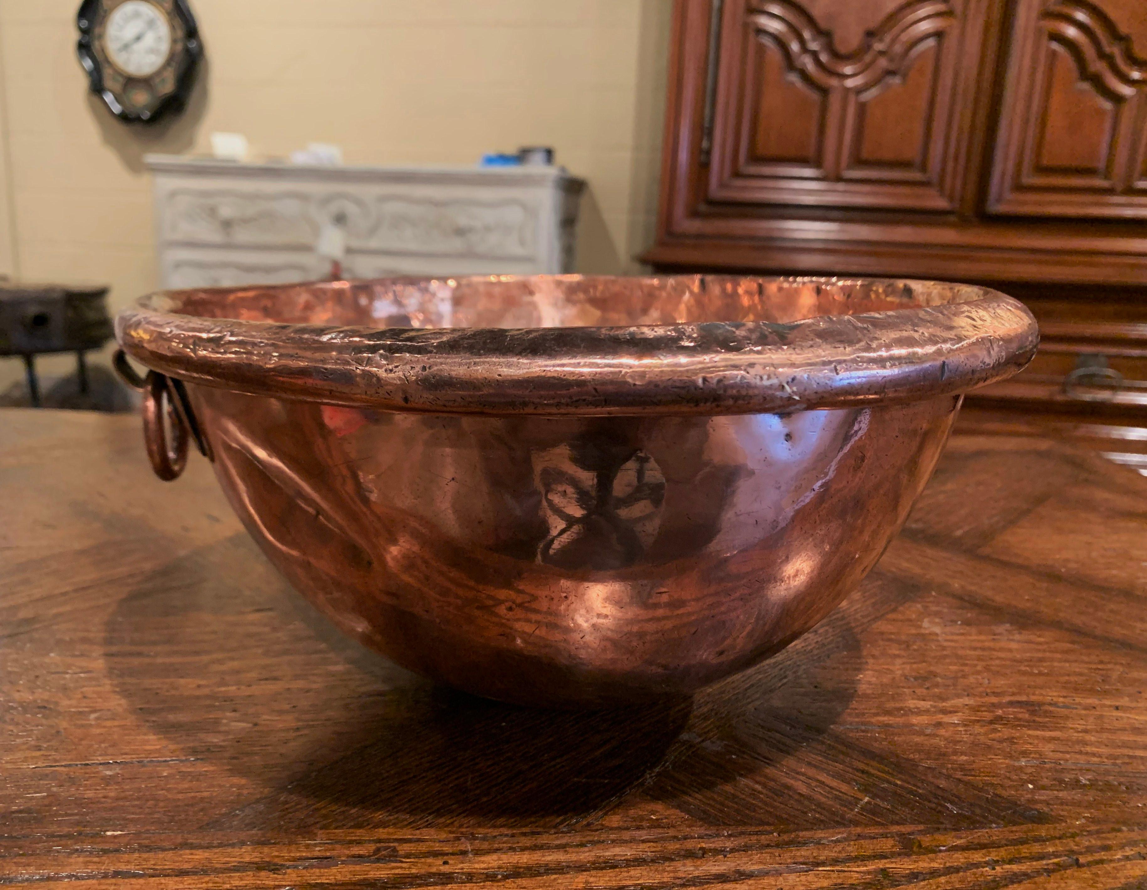 Keep your wine chilled in style with this elegant round bowl, crafted in Northern France circa 1780 and originally used for home made jelly, the circular copper bowl with rounded rim and a small round side handle attached with rivets. The dish is in