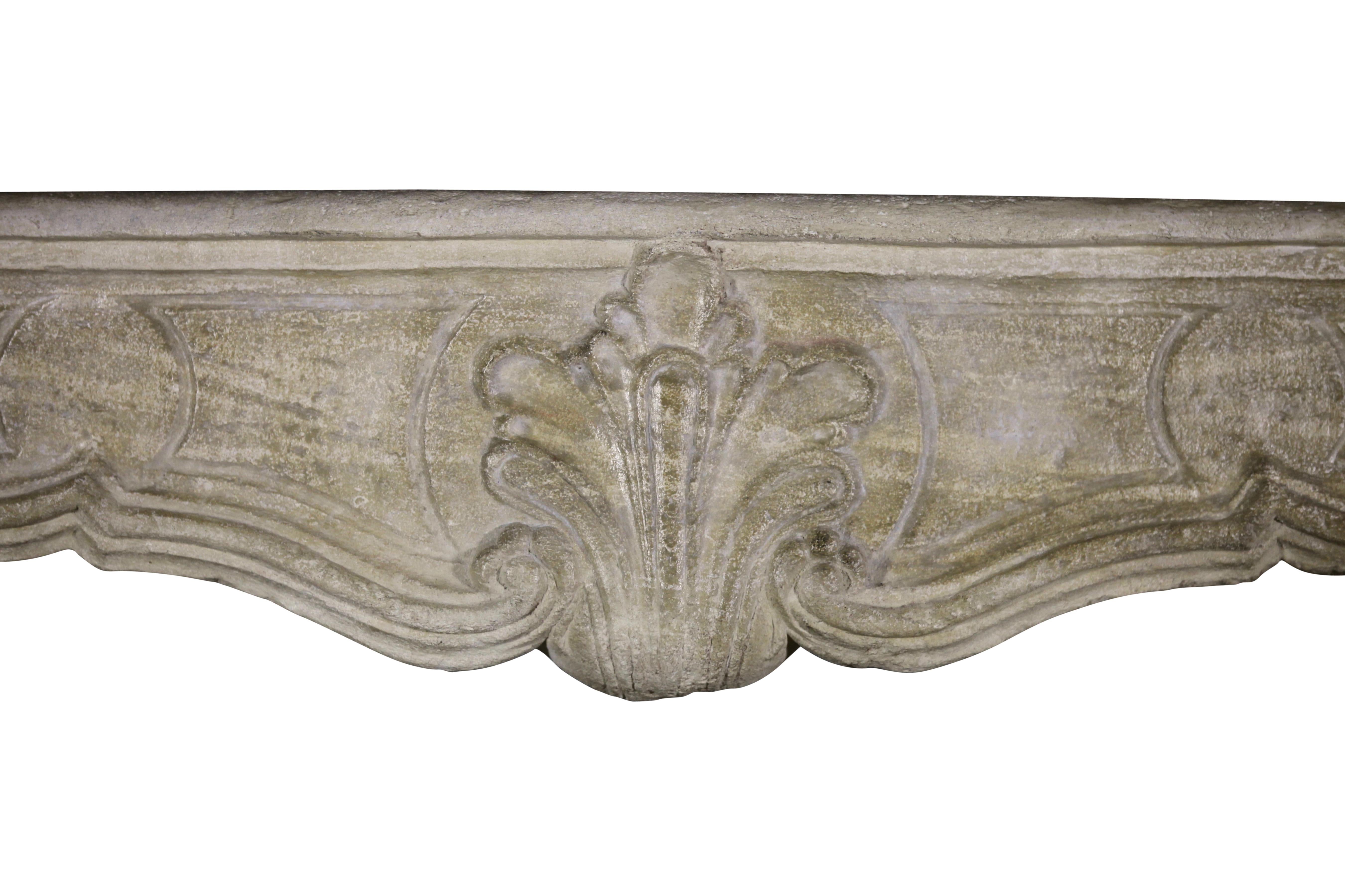 This original limestone French country Louis XIV period fireplace mantel has a great patina. Some restorations were made and barely to notice. When touching it, it has a silky feeling. A perfect mantel for a country rustic interior with a small
