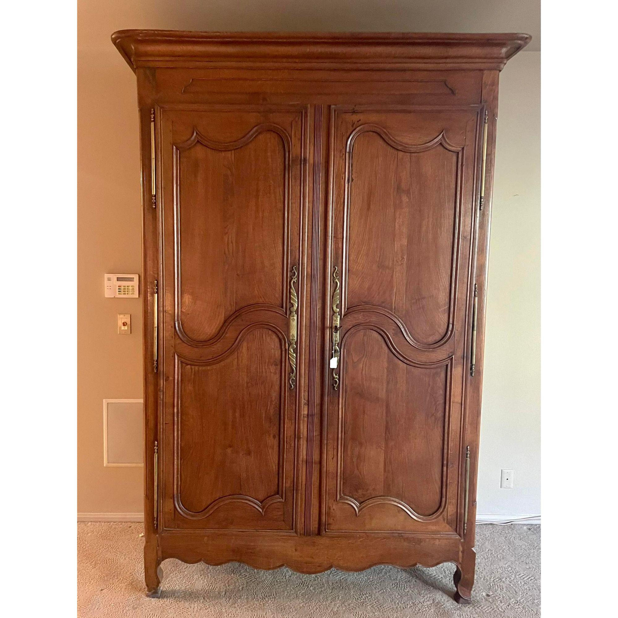 18th Century French Country Armoire Linen Press Wardrobe Cabinet. It features carved provincial details and a customized interior with tailored drawers. Includes original 18th century lock and key

Additional information: 
Materials: Fruitwood,