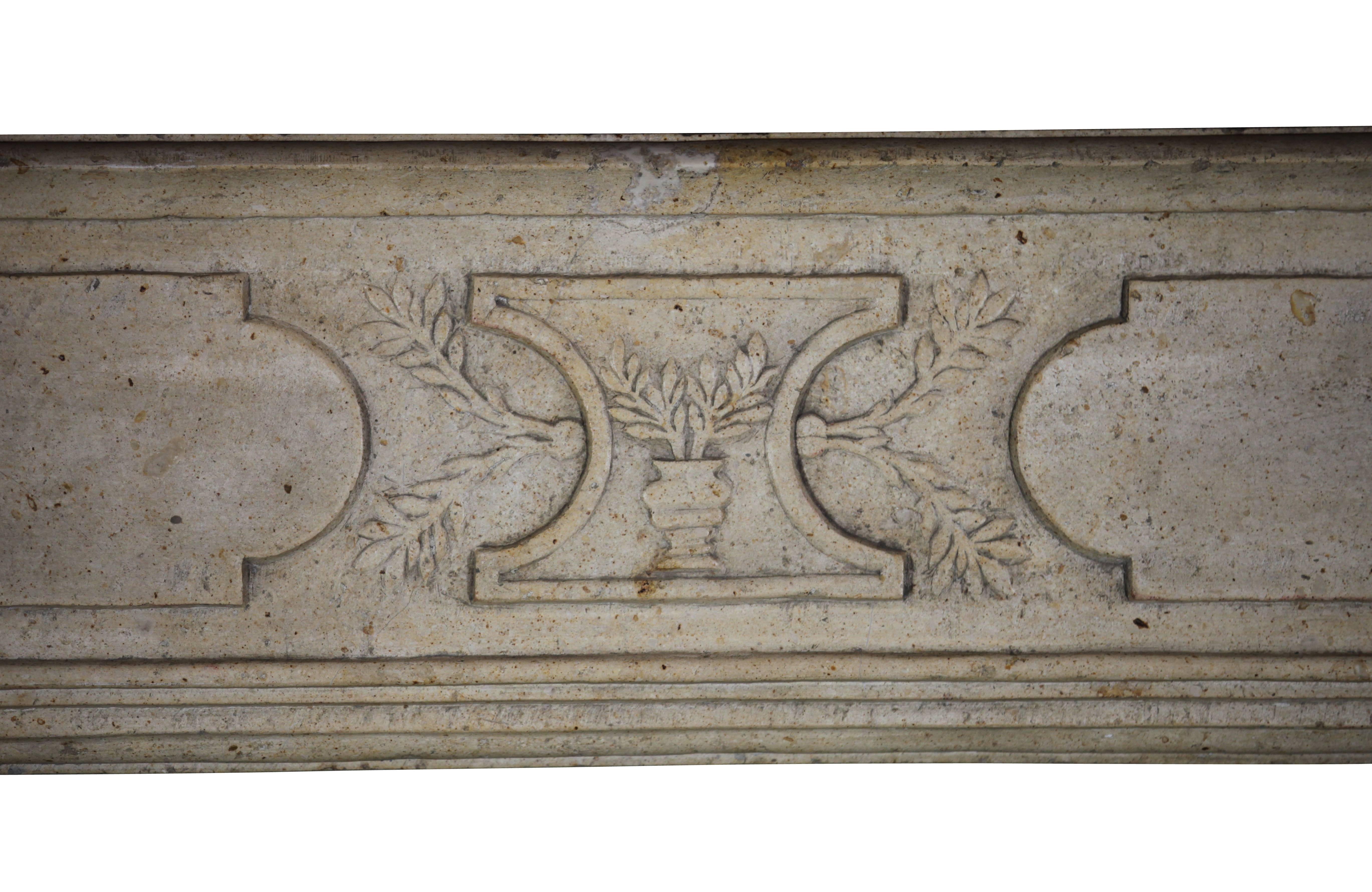 French country hard limestone fireplace mantel which is specially commissioned for a vigneron, a person who cultivates grapes for wine making. The hardness of the stone reflects the light in the room. This is a real eye-catcher for someone who loves