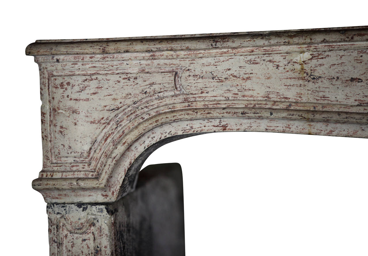 Magnificent, one of a kind French antique fireplace mantle in limestone with original patina. The special design is from the Louis XIV period, 18th century. The mantel is in great shape! The stone has a gloss shine reflecting the light in a room.