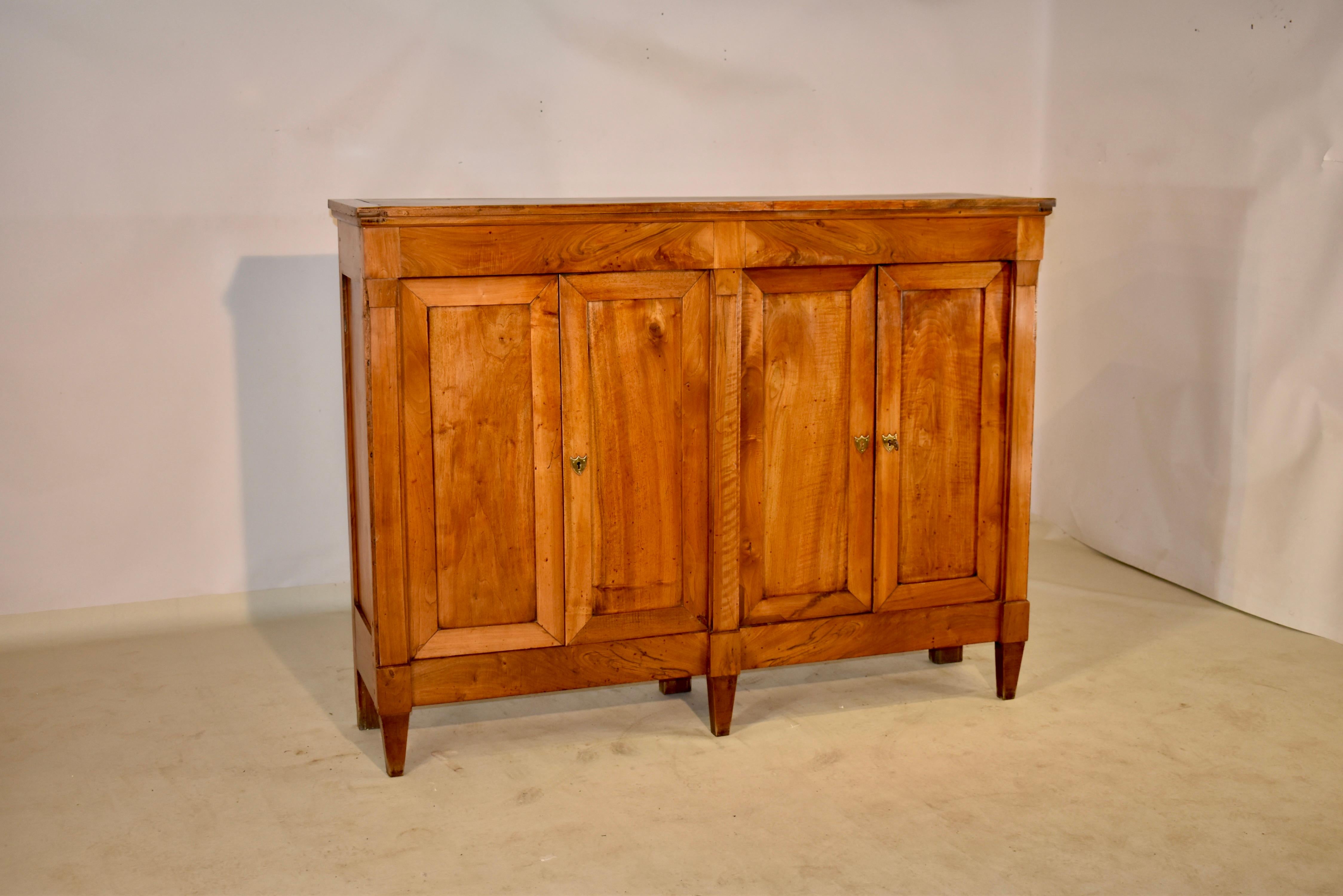 Late 18th century French buffet from the Director period. The piece is made from walnut and cherry and was lovely figuring to the wood. the top is banded and follows down to paneled sides and two pairs of doors in the front which open to reveal