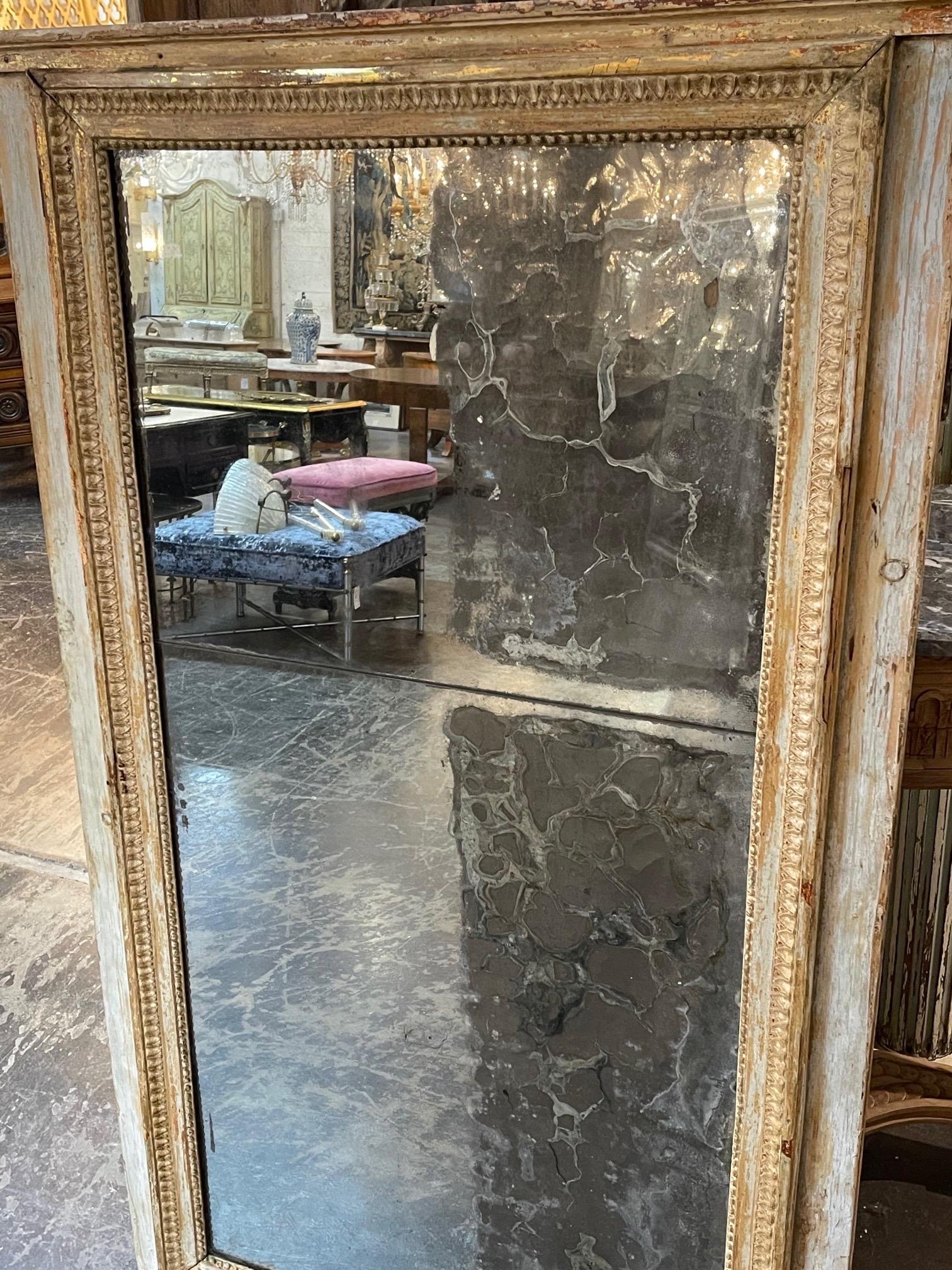 Pretty 18th century French Directoire divided glass mirror. Very nice patina on the frame with the colors of grey and gold. The mirror is original mercury glass.