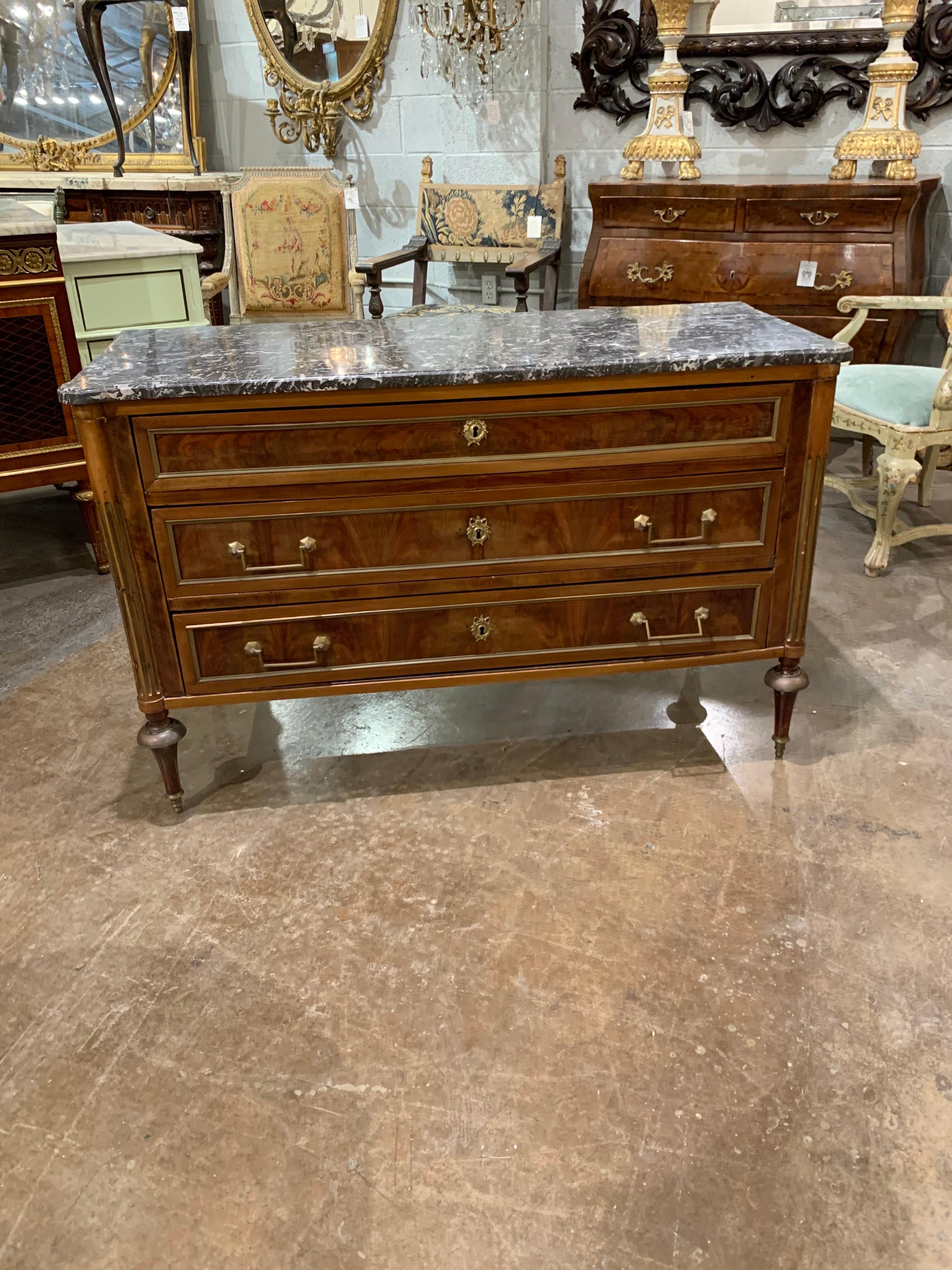 Fabulous period 18th century French Directoire mahogany commode with brass trim. This piece also has a gorgeous original grey marble top. True elegance!