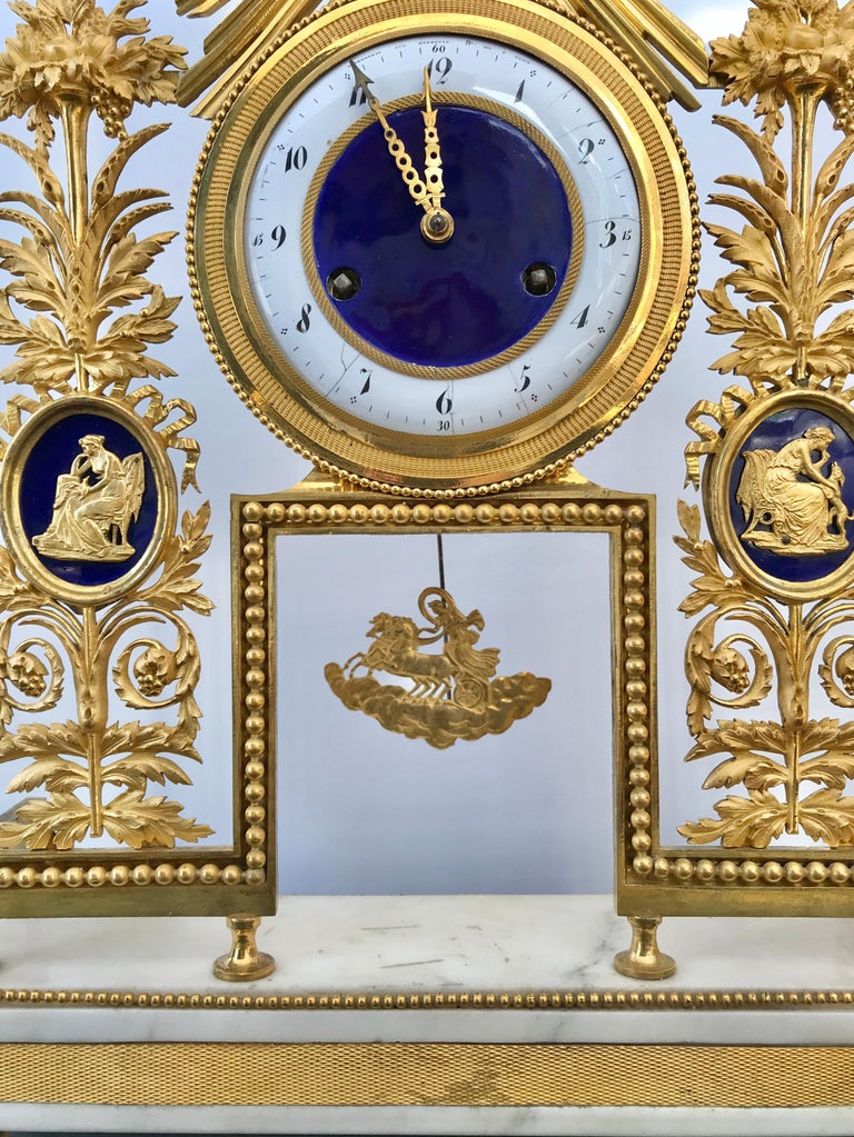Period French marble and ormolu mantel clock with sunburst or sun king motif original works. Gilding in great condition. Neoclassical form with enamel embellishments in great condition as well Directoire marble and gilt-bronze clock, France, late