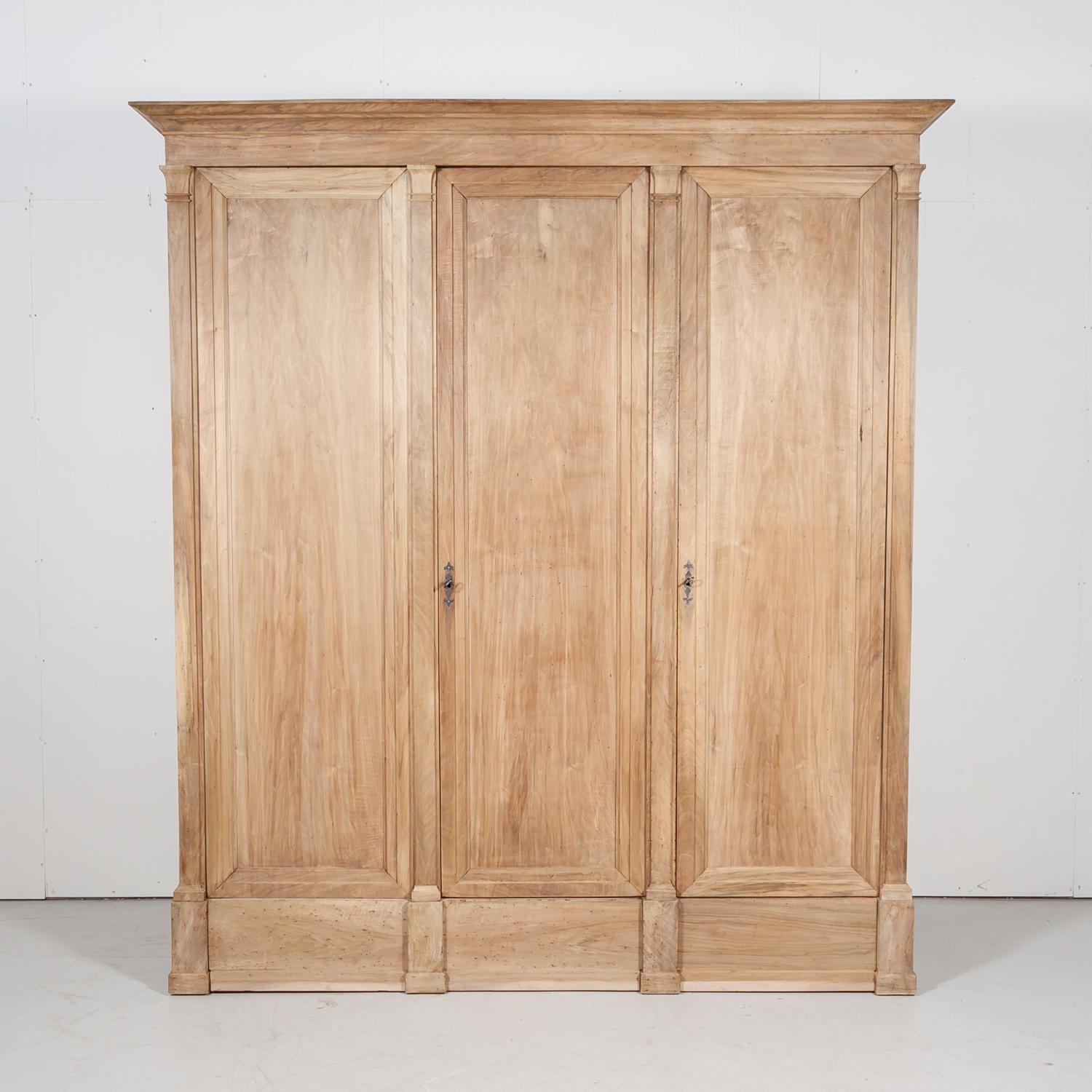 Monumental 18th century French Directoire period placard or wardrobe handcrafted of solid walnut by skilled artisans in the South of France near Arles, circa 1780s. custom made for a country chateau, this walnut placard has been bleached or washed