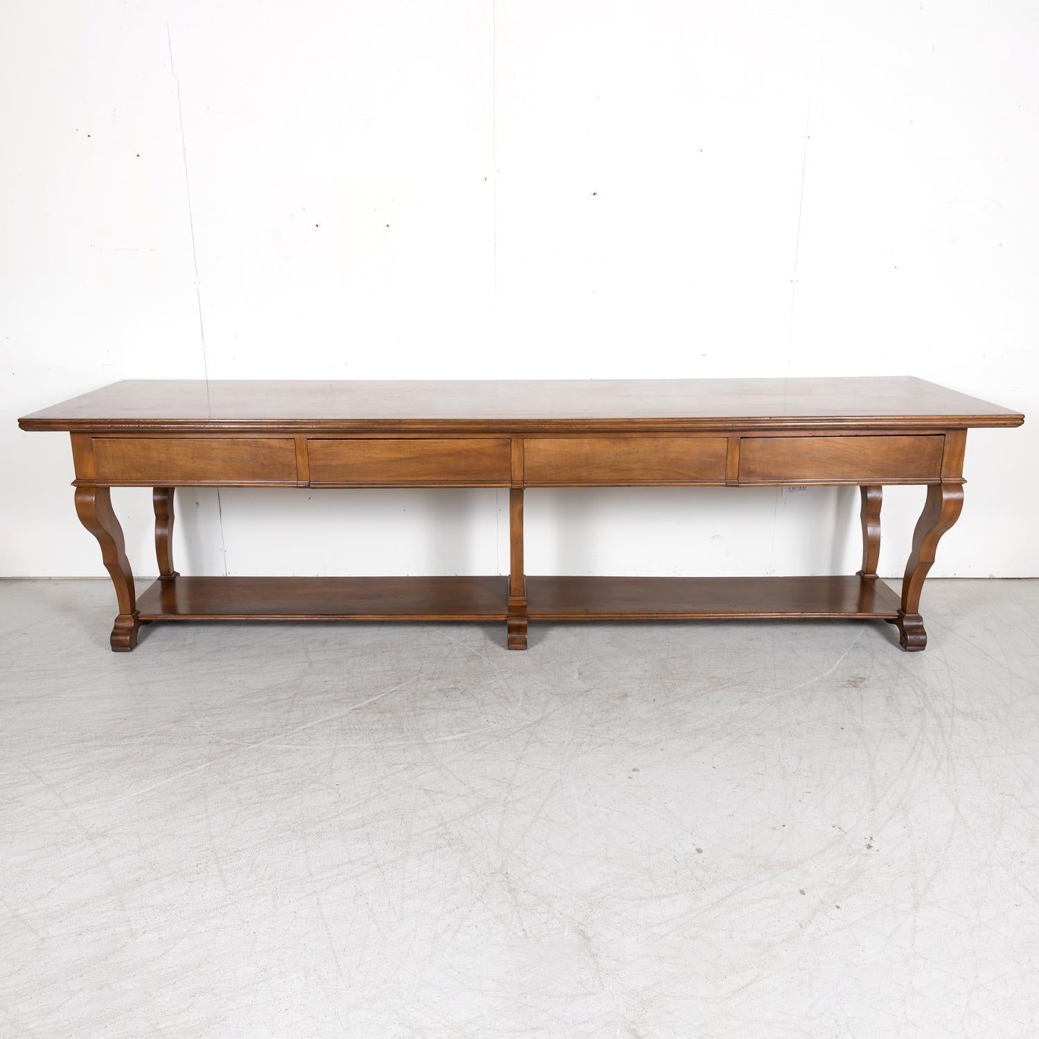 A grand 18th century French Directoire period table de drapier from a draper's atelier in Narbonne, a wealthy port city in Southern France in the Occitanie region, circa 1780s. Handcrafted of solid walnut with a marquetry baguette or band on the
