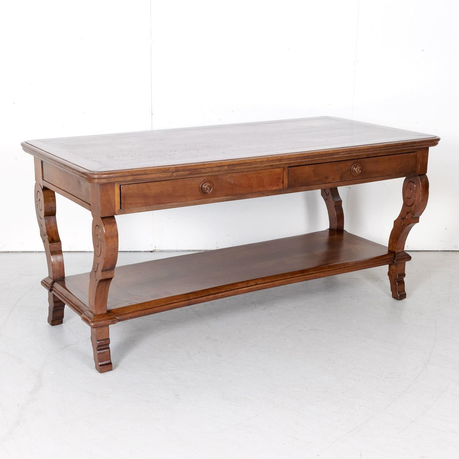 A fine late 18th century French Directoire period table de drapier from a draper's atelier in Lyon, circa 1790s. Handcrafted of solid walnut, this beautiful draper table, with its elegantly carved legs, was a common feature in the cloth merchant’s