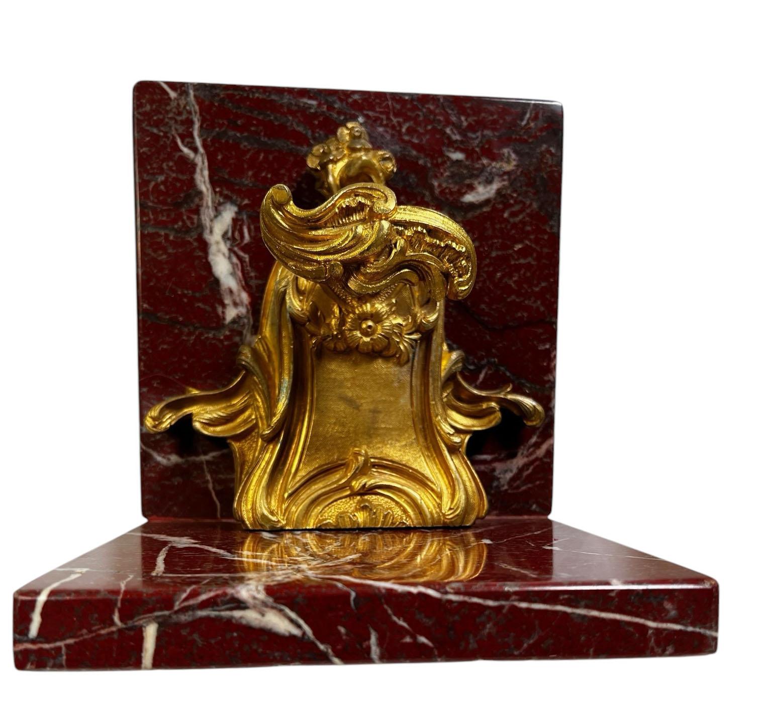 A pair of 18th century French door locks artfully repurposed into elegant bookends. Each lock, originally crafted circa in 1790, features intricate bronze doré detailing and unique turn handles, showcasing the refinement of French craftsmanship.