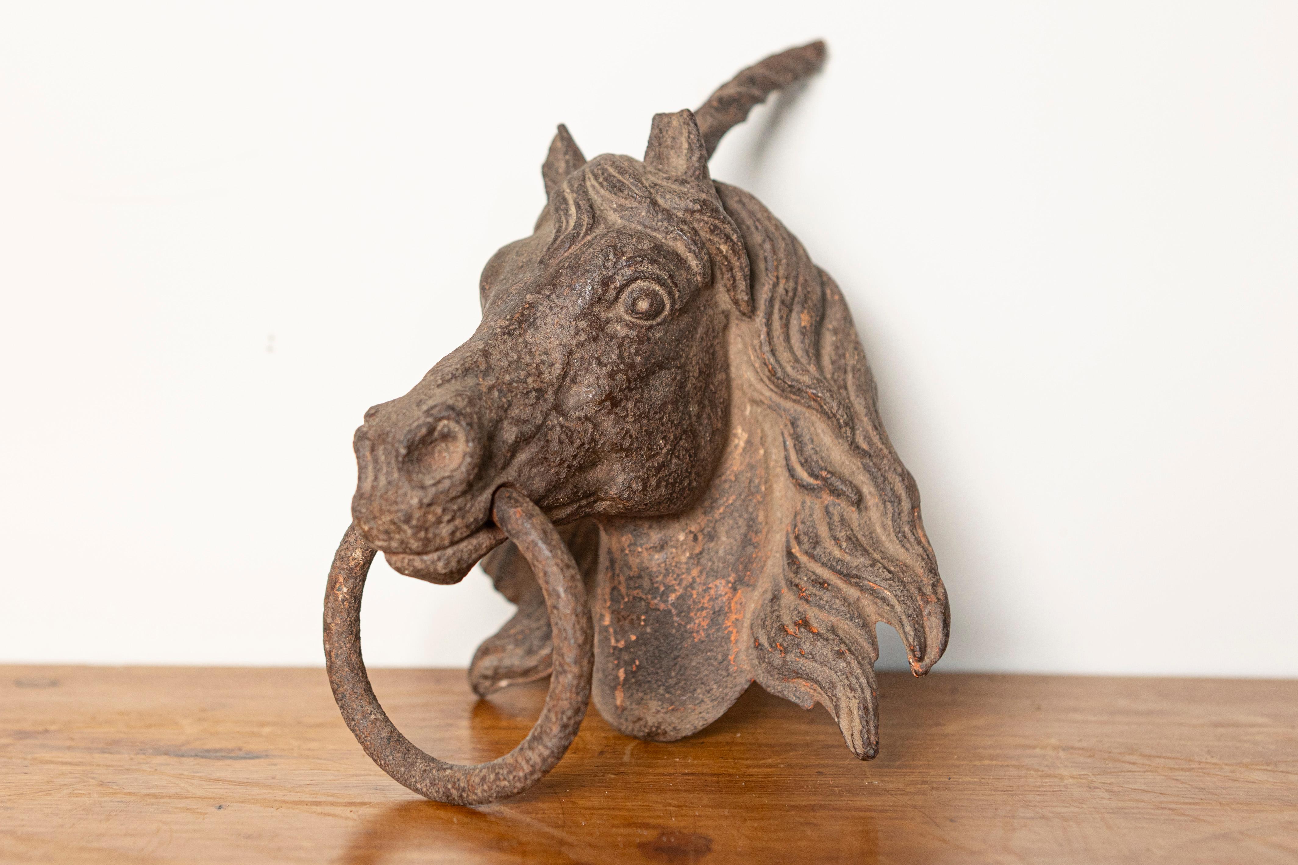 This impressive 18th-century French cast iron horse head ornament is a striking piece of architectural decor originally designed as an exterior embellishment for a grand estate or stable. Expertly cast with exceptional detail, the horse's expressive