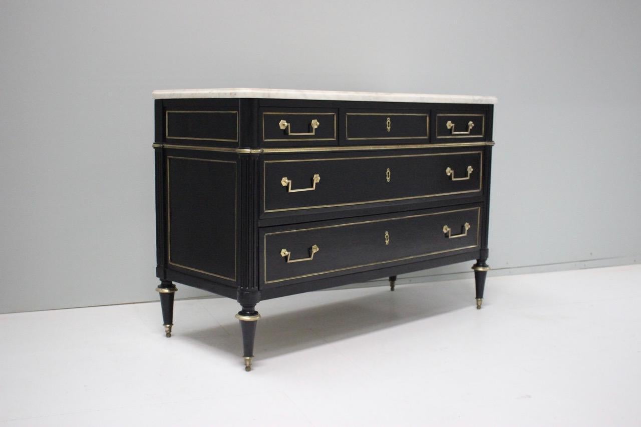 A very elegant, late 18th century French, Louis XVI ebonized commode of elegant proportions and good presence, retaining the original marble-top.
       