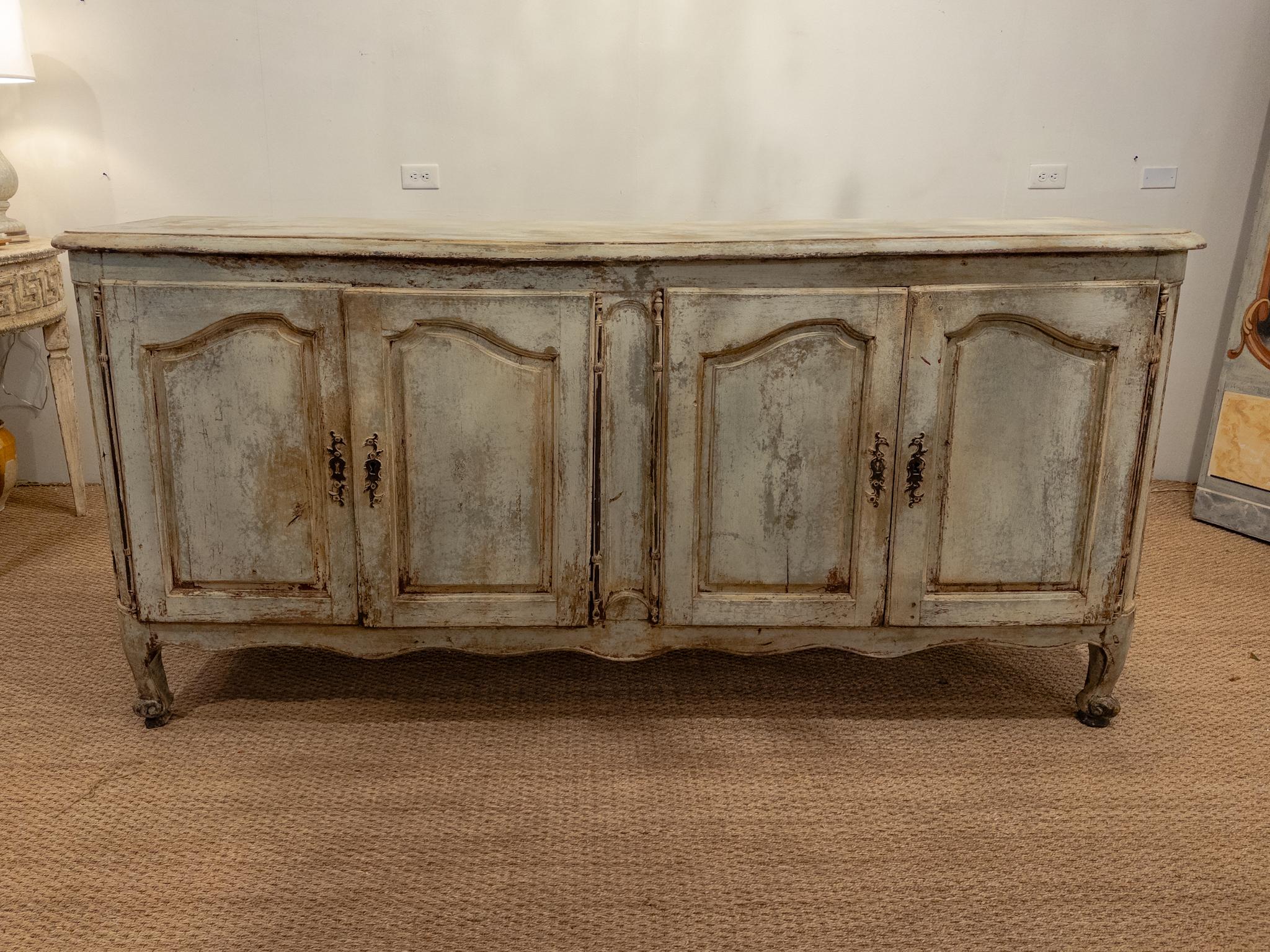 The 18th Century French four-door enfilade epitomizes the opulence and refinement of its era, showcasing exquisite craftsmanship and intricate detailing. Its original patina and hardware lend an air of authenticity, preserving the allure of bygone