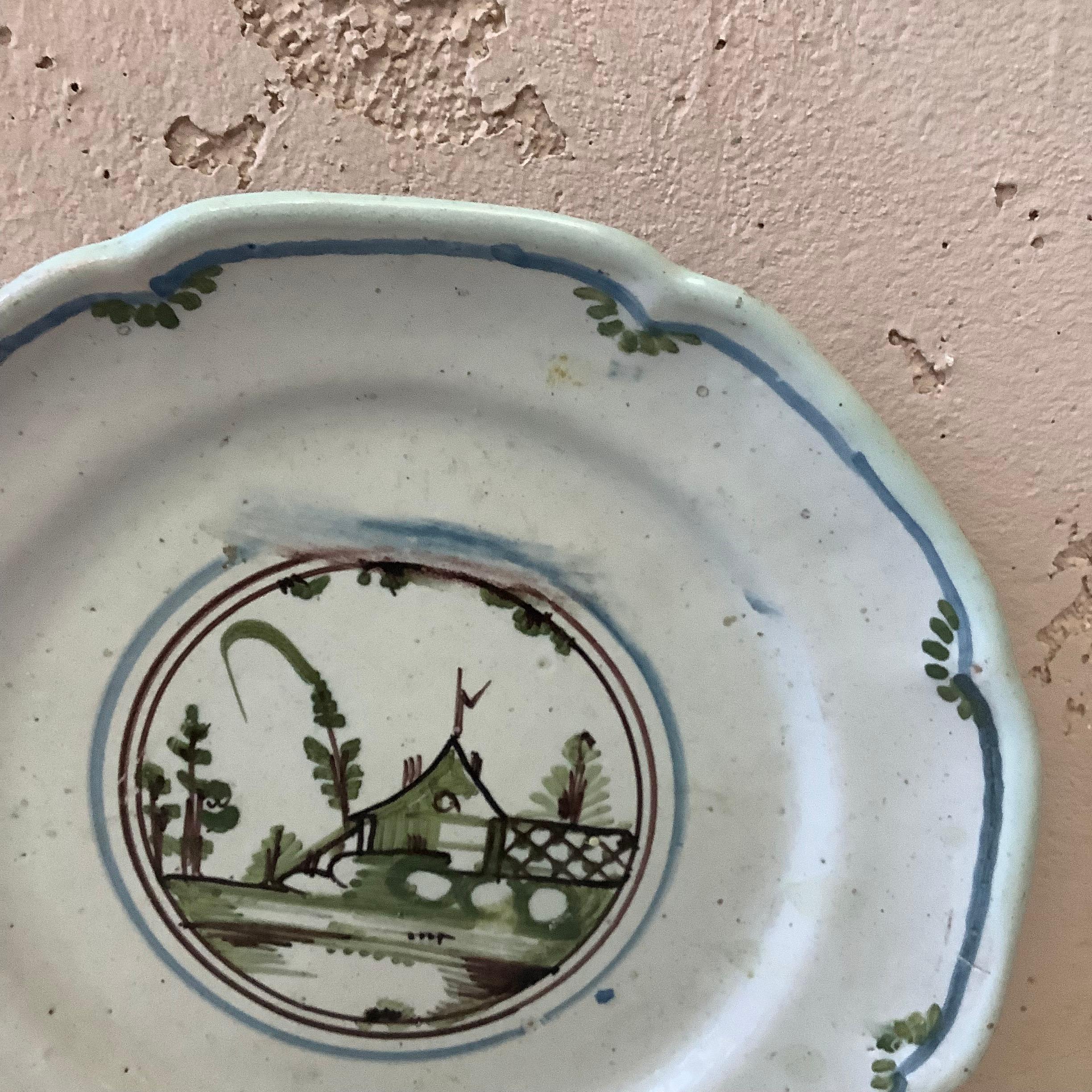 18th century French faience Nevers plate.
House with trees on the center.