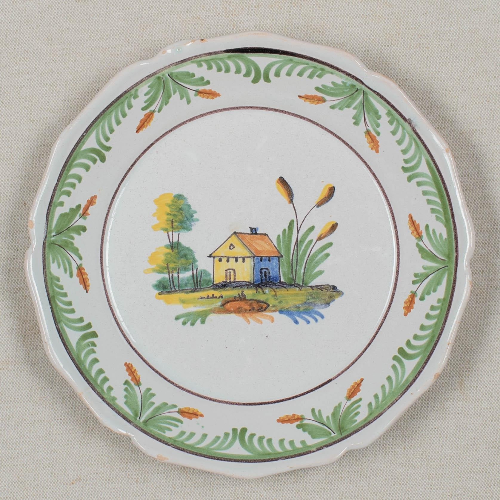 An 18th century French faience plate with primitive hand painted decoration of a house. Minor chips and glaze losses on edges of scalloped rim. No hairline cracks or restorations noted. Circa 1780-1800
Dimensions: 9