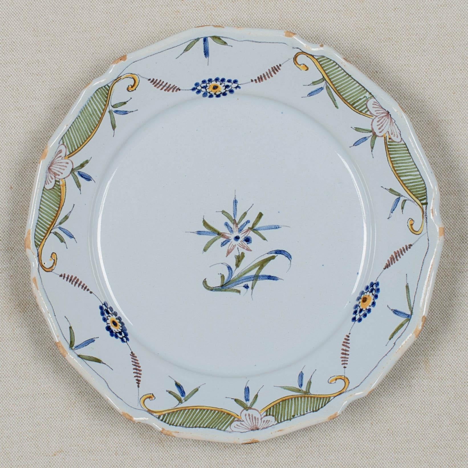 An 18th century French faience plate with primitive hand painted decoration. Minor chips and glaze losses on edges of scalloped rim. No hairline cracks or restorations noted. Circa 1780-1800
Dimensions: 9