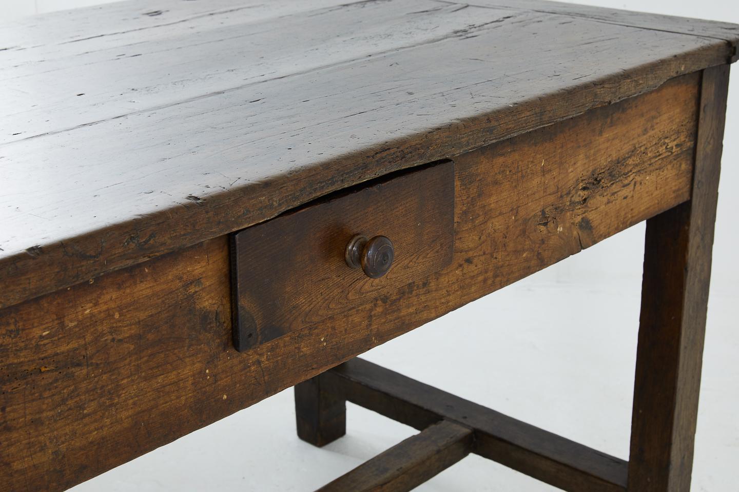 A rustic, charming and well used 18th century French farmhouse table with cherrywood top and oak base.
 