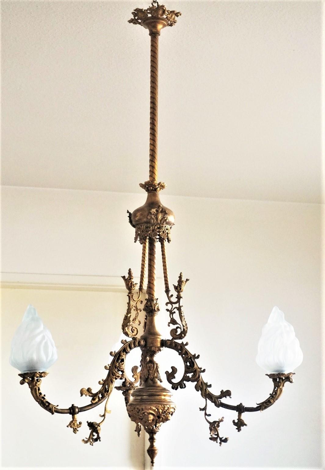 A very fine, large fire-gilded bronze church chandelier in Louis XVI style, France, late 18th century. This wonderful piece is finely elaborate in precise detail decorated with elegant foliate, flowers and cherub faces, three curved arms with