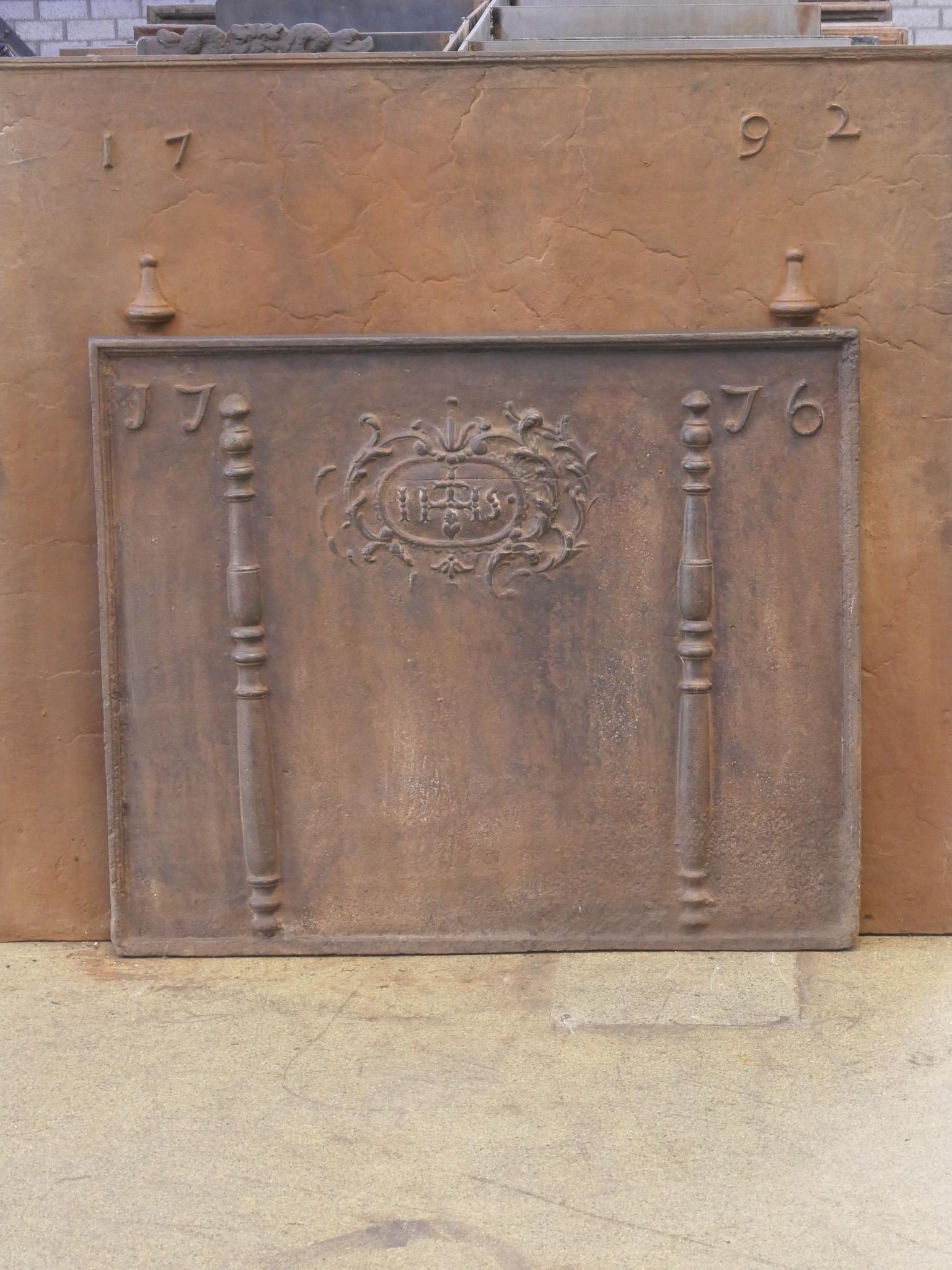 18th century Louis XV period French fireback with pillars, two IHS monograms, and the date of production 1776.

The monogram IHS stands for Iesus Hominum Salvator (Jesus the Savior of Humanity) or In Hoc Signo (In this sign will you win). The