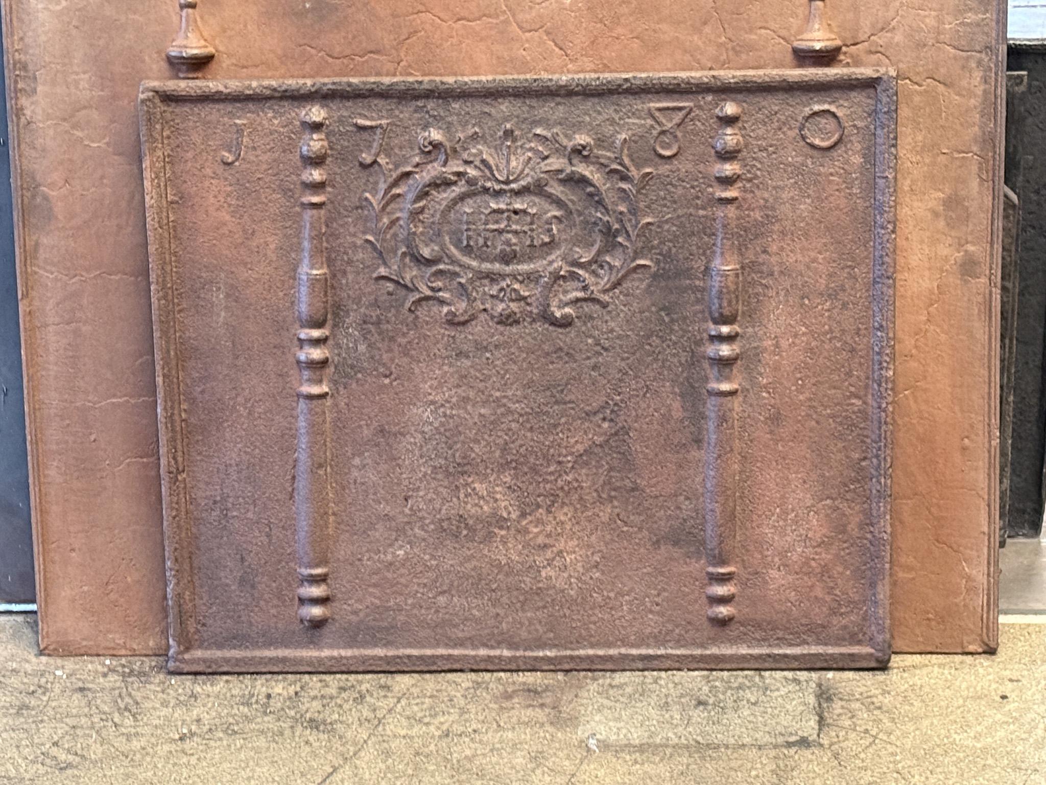 18th century Louis XIV Period French fireback with pillars, an IHS monogram, and the date of production 1780.

The monogram IHS stands for Iesus Hominum Salvator (Jesus the Savior of Humanity) or In Hoc Signo (In this sign will you win). The pillars