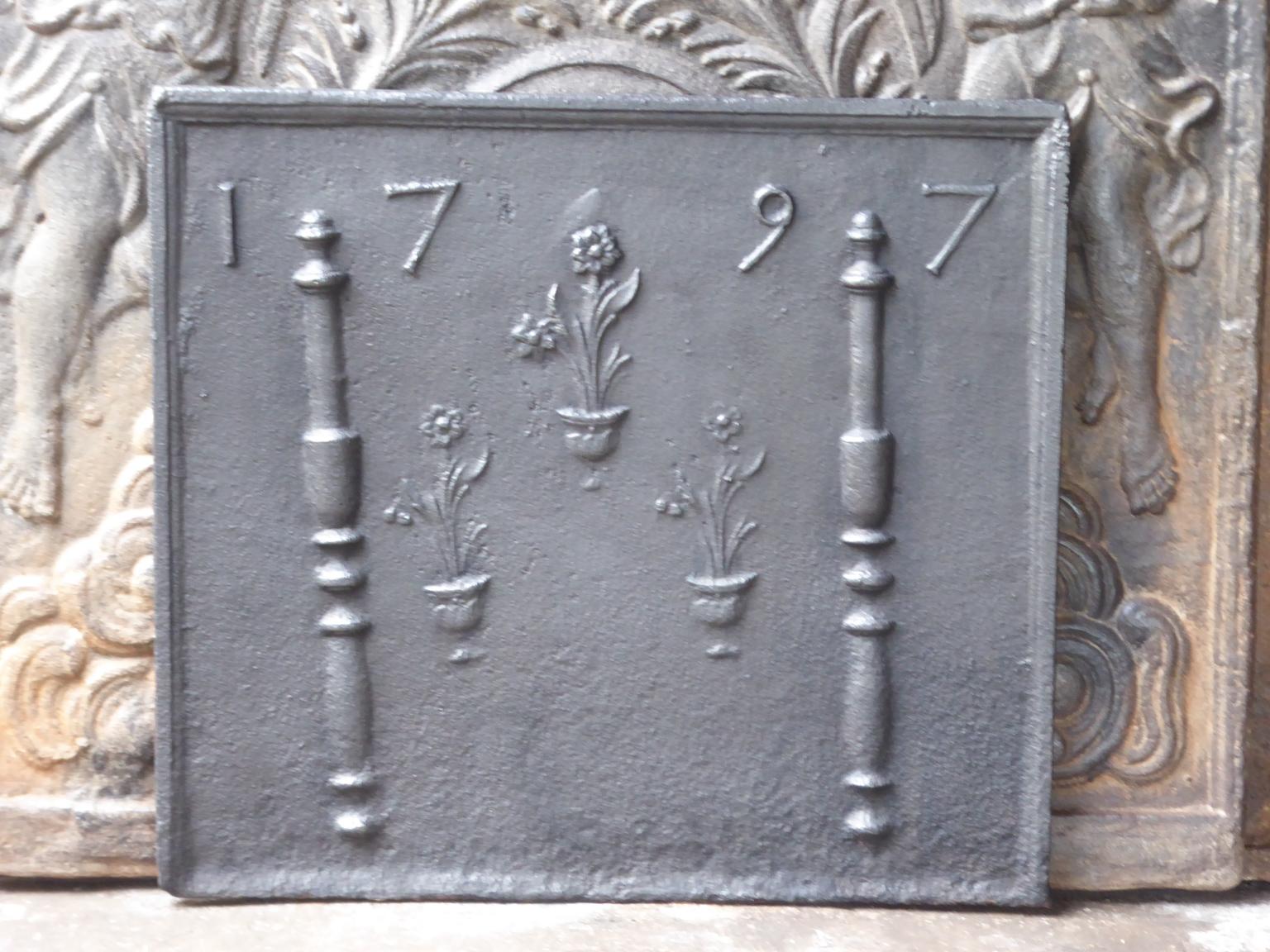 18th century Louis XV French fireback with pillars, flower vases and the date of production 1797. The pillars refer to the club of Hercules and stand for strength and the unknown.

The fireback is made of cast iron and has a black / pewter patina.