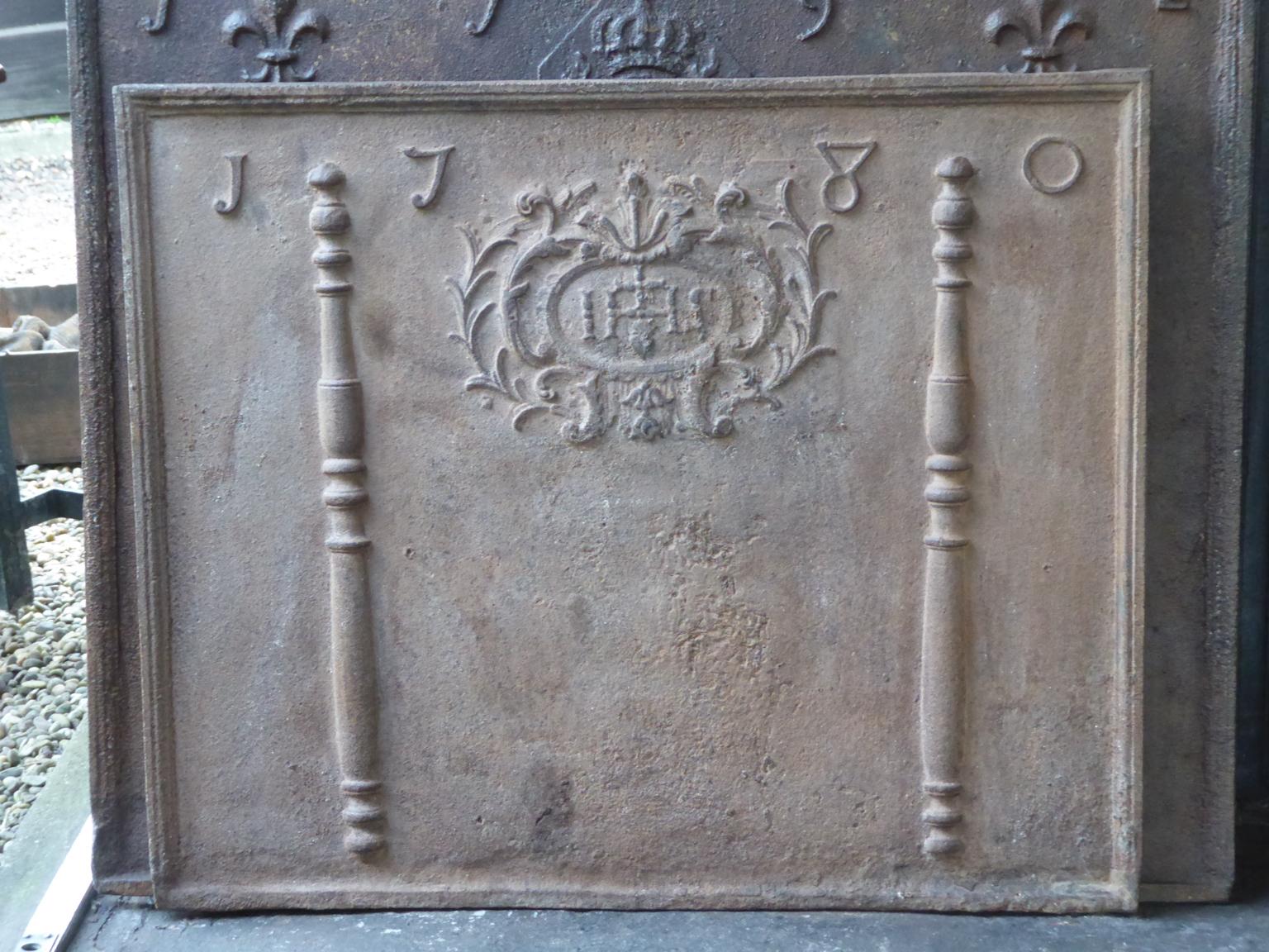 18th century Louis XV French fireback with pillars of Hercules, an IHS monogram, and the date of production 1780.

The monogram IHS stands for Iesus Hominum Salvator (Jesus the Savior of Humanity) or In Hoc Signo (In this sign will you win). The