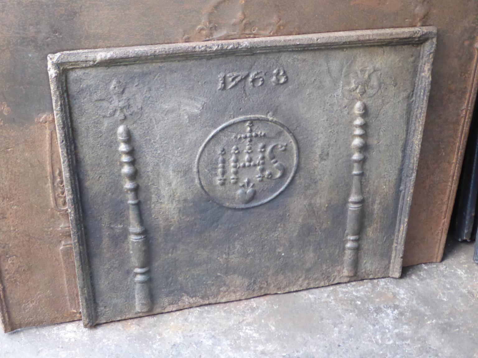18th century Louis XIV French fireback with pillars, an IHS monogram and the date of production 1768. The monogram IHS stands for Iesus Hominum Salvator (Jesus the Savior of Humanity) or In Hoc Signo (In this sign will you win). The pillars refer to