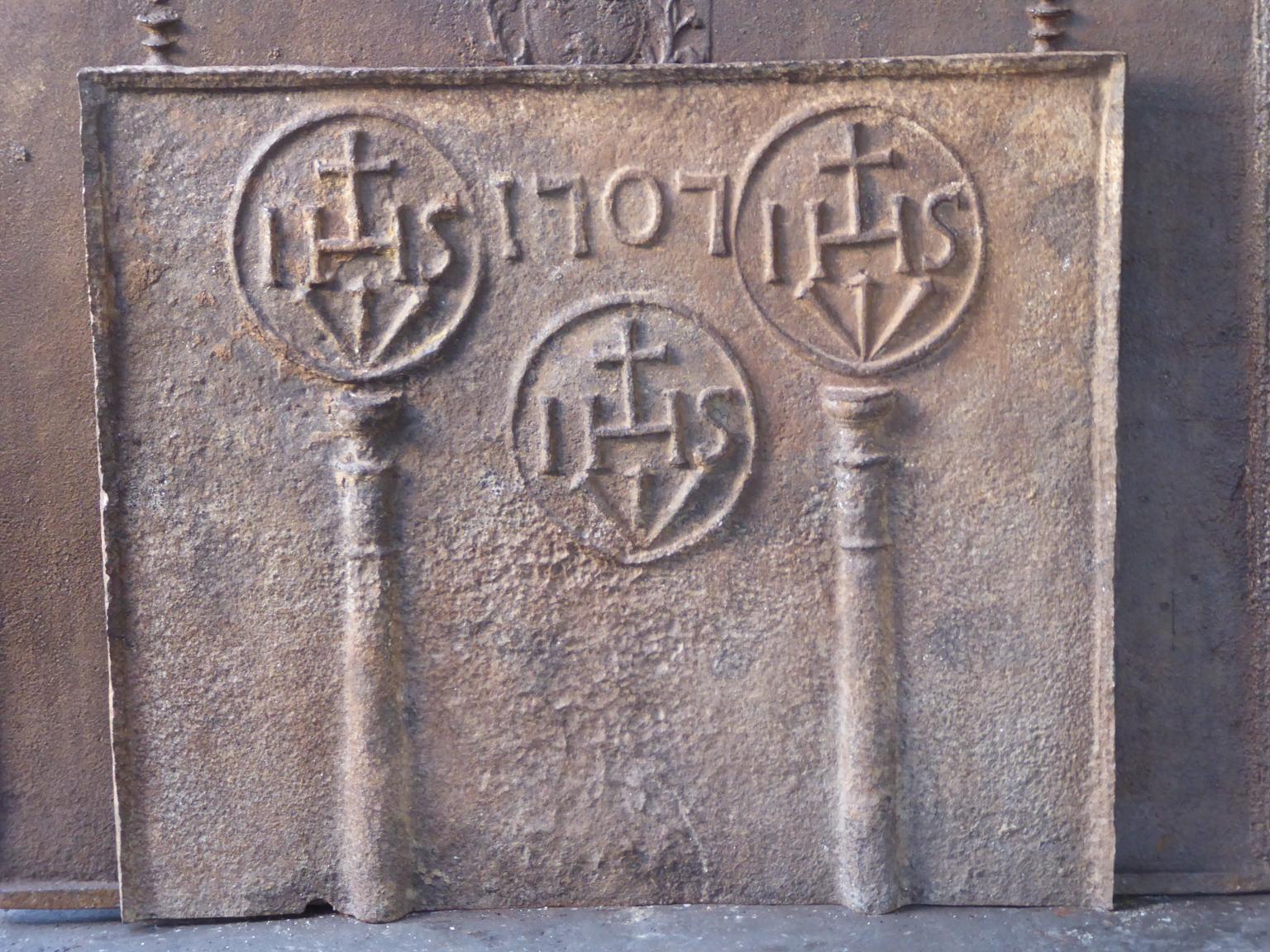 18th century Louis XIV French fireback with pillars, three IHS monograms, and the date of production 1707.

The monogram IHS stands for Iesus Hominum Salvator (Jesus the Savior of Humanity) or In Hoc Signo (In this sign will you win). The pillars