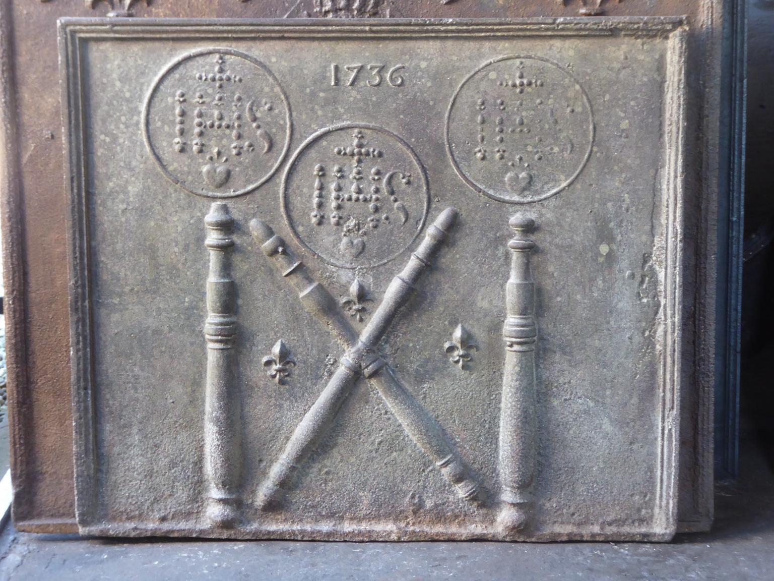 18th century Louis XIV French fireback with pillars, three IHS monograms, and the date of production 1736.

The monogram IHS stands for Iesus Hominum Salvator (Jesus the Savior of Humanity) or In Hoc Signo (In this sign will you win). The pillars