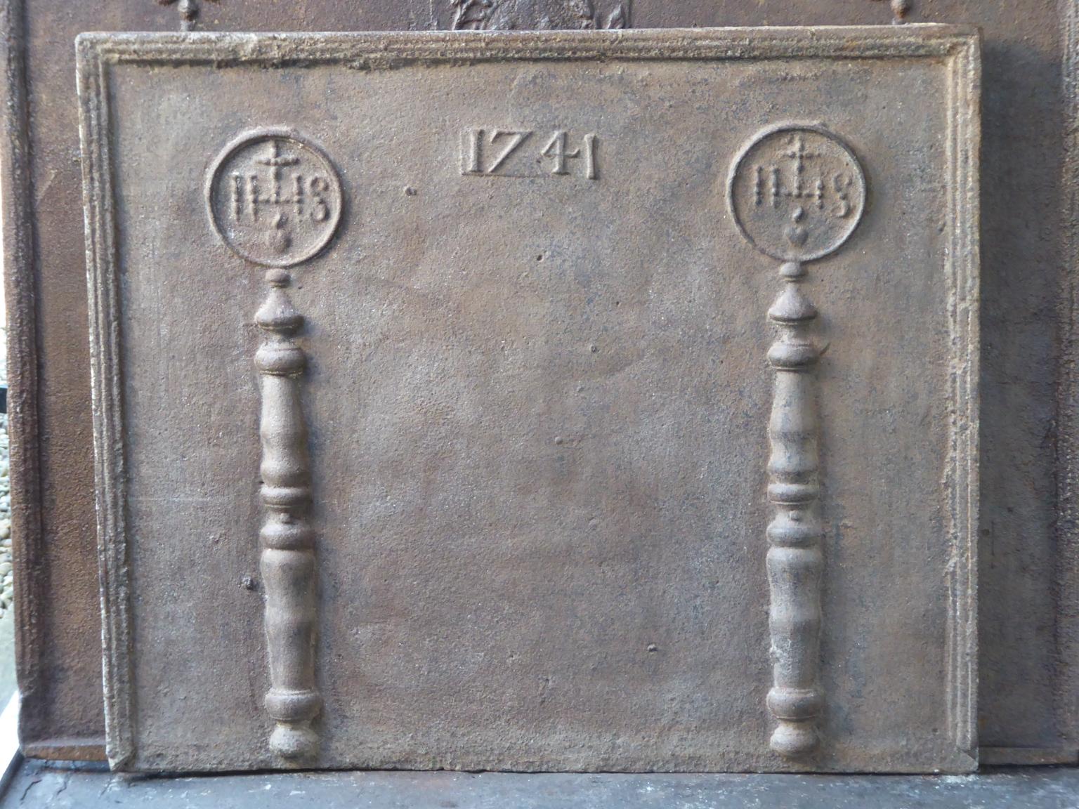 18th century Louis XIV French fireback with pillars, two IHS monograms, and the date of production 1741.

The monogram IHS stands for Iesus Hominum Salvator (Jesus the Savior of Humanity) or In Hoc Signo (In this sign will you win). The pillars