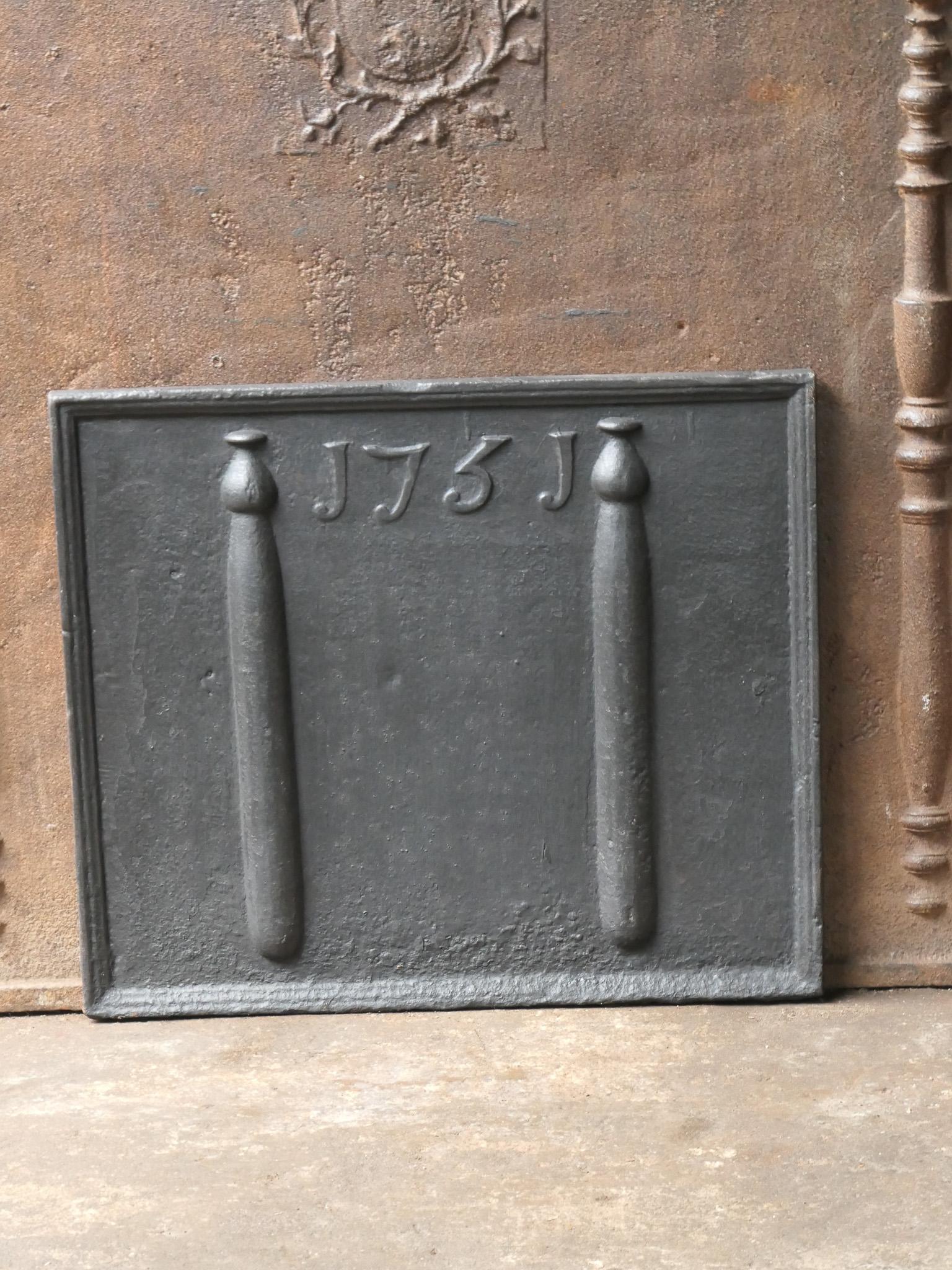18th century French Louis XIV fireback with pillars of Hercules. The pillars stand for the club of Hercules and symbolize strength and the unknown. The date of production, 1751, is also cast in the fireback. 

The fireback has a black / pewter