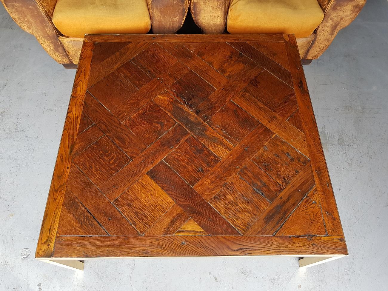 Modern look 18th century French oak floor panel made in to a coffee table with polished brass base, second half of the 20th century.

The measurements are:
Depth 104.5 cm/ 41.1 inch.
Width 104.5 cm/ 41.1 inch.
Height 40.5 cm/ 15.9 inch.