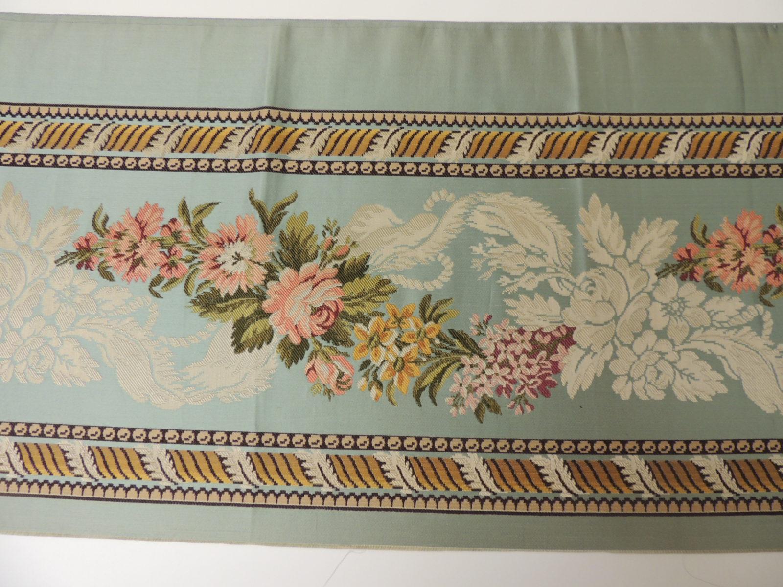 18th century French floral green and pink satin silk brocade textile.
Unique woven silk textile depicting flowers and a twisted design border. Narrow woven textile.
Depicts flowers in bloom with bows, ribbons and acanthus leaves borders.
In