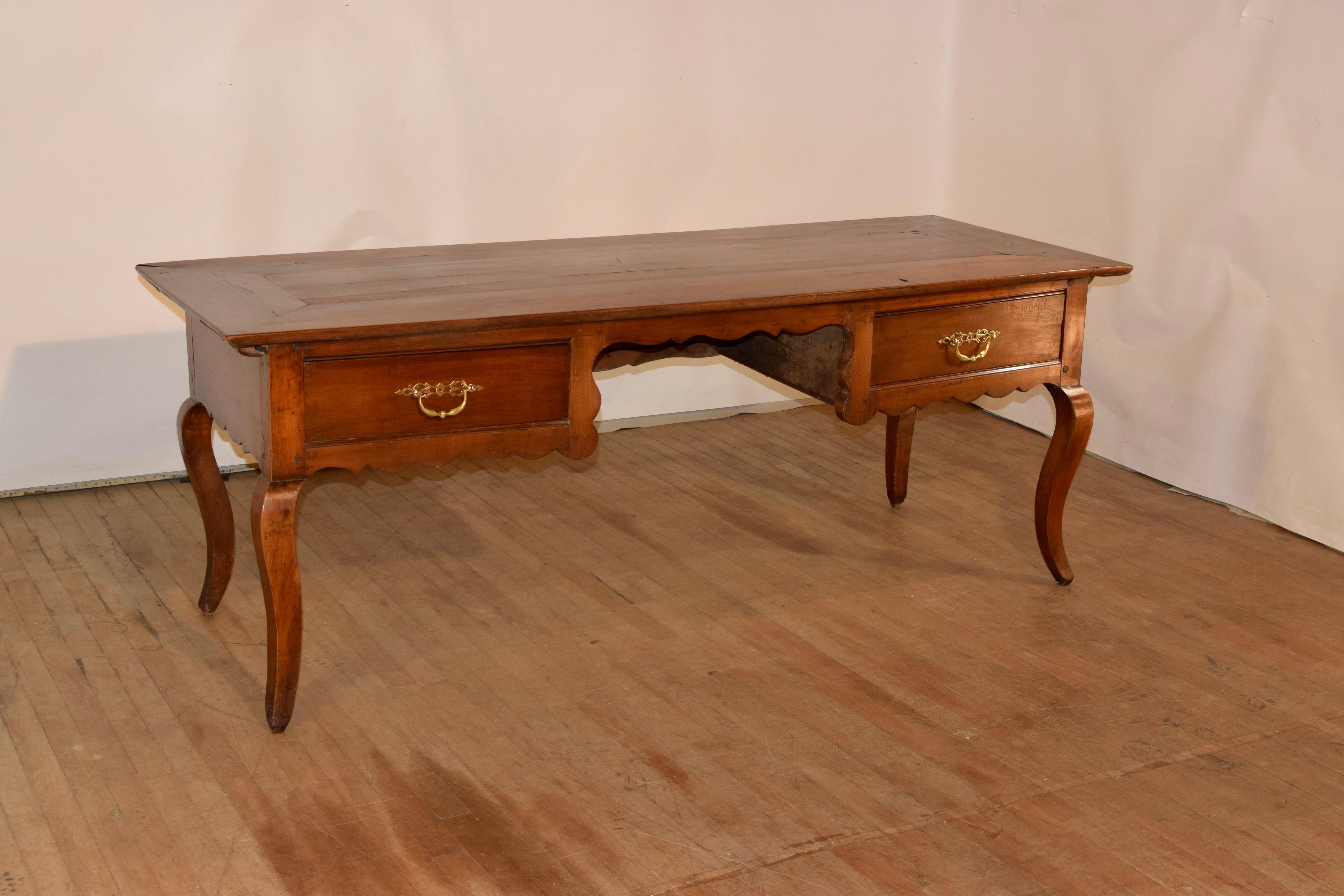 18th century fruitwood desk from France with a gorgeously banded top over simple and scalloped sides and two drawers in the front flanking a knee hole, which measures 26 inches in height to the apron of the desk. The back of the desk is hand paneled
