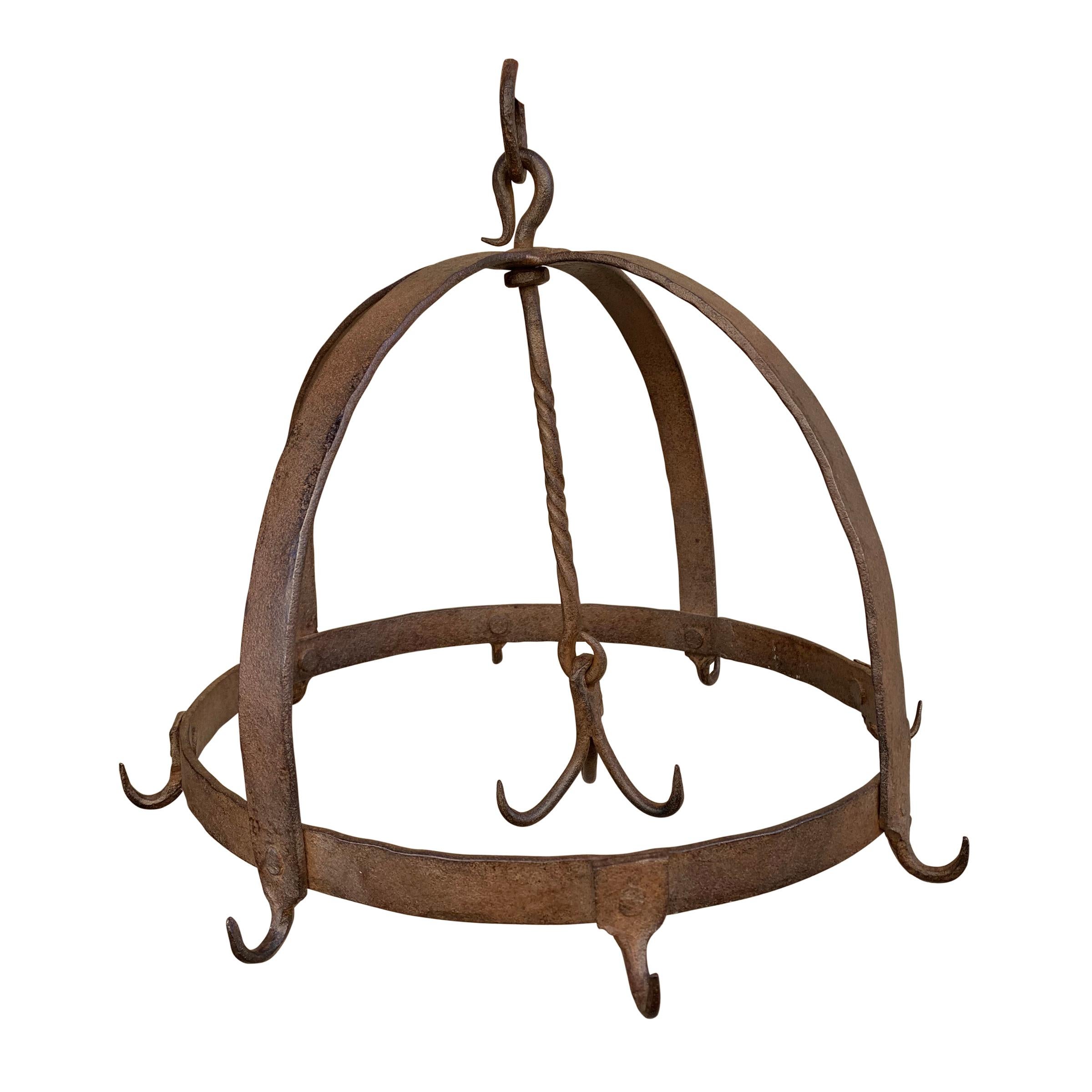 A beautiful 18th century French handwrought iron game rack with one outer ring with eight hooks, and three more hooks that hang in the center from a twisted rod. Game racks were used to age pheasants, rabbits, or any other small game, after the