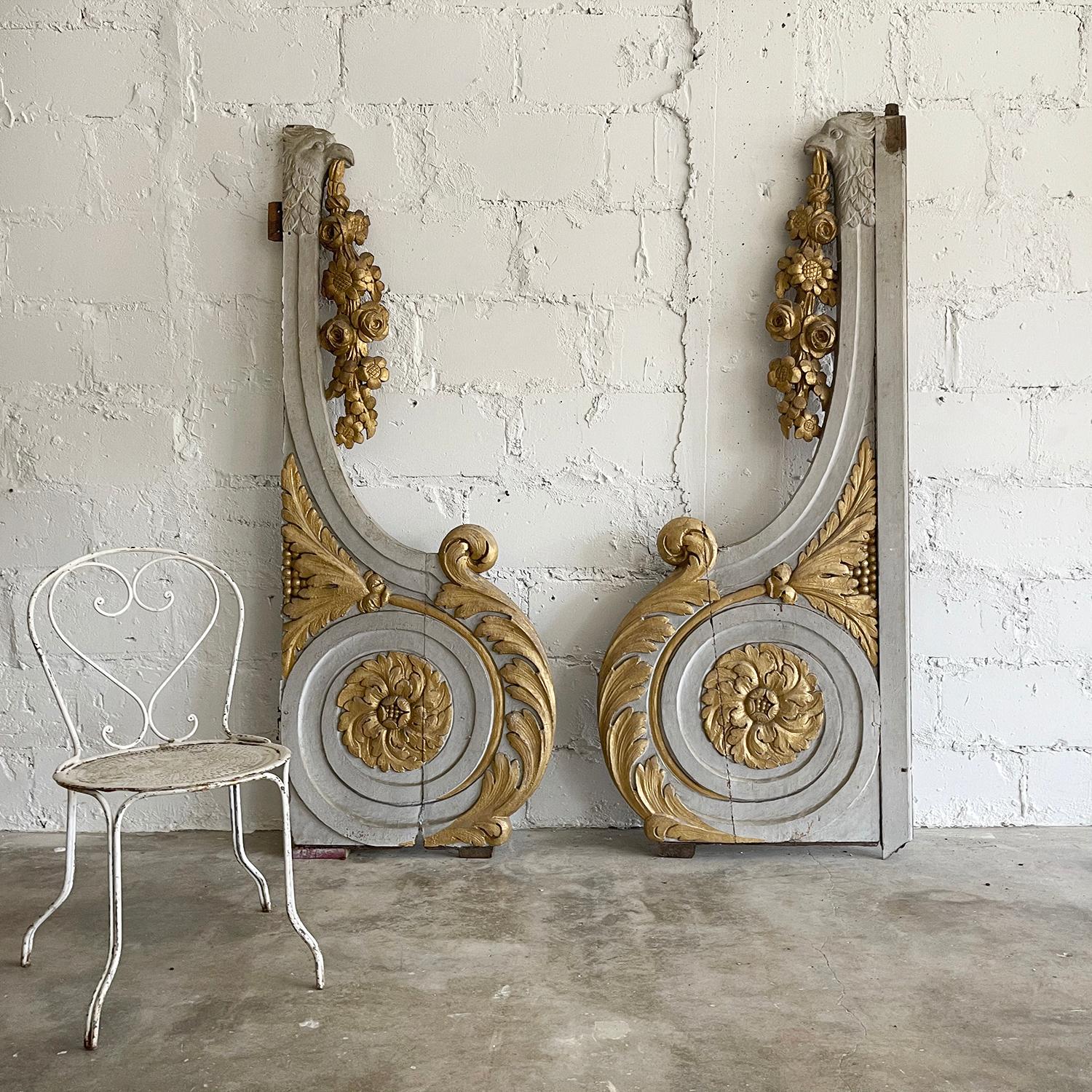 An antique pair of French Baroque painted and partial, gilt carved architectural elements or wall panels, in good condition. These ornaments are very ornate and decorated with large rosettes, fruit garlands and scrolls. One fragment is larger than