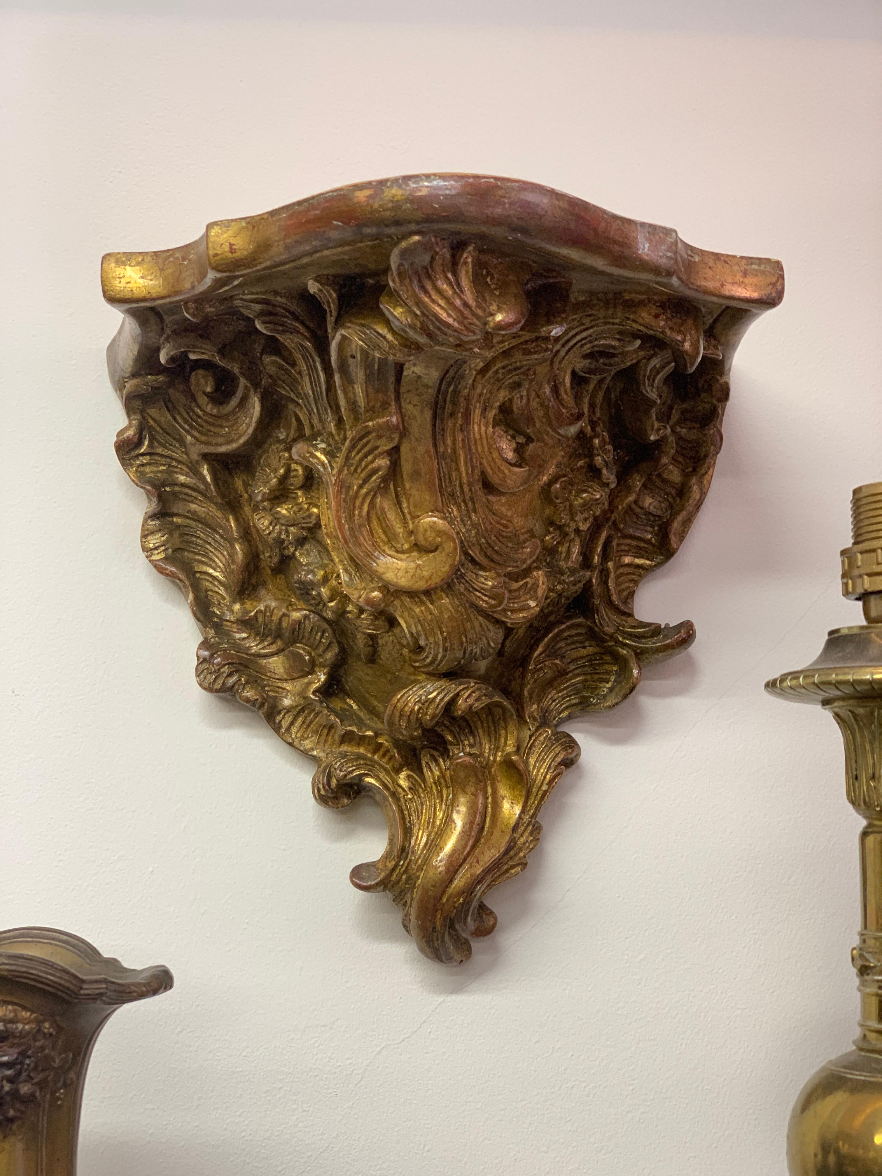 18th century wall suspended consoles from France. Beautifully constructed in gilt wood and ornamented with a Rococo influence. The quality of the carving and gilding is very good and they fit perfect on any wall especially under columns. There is a
